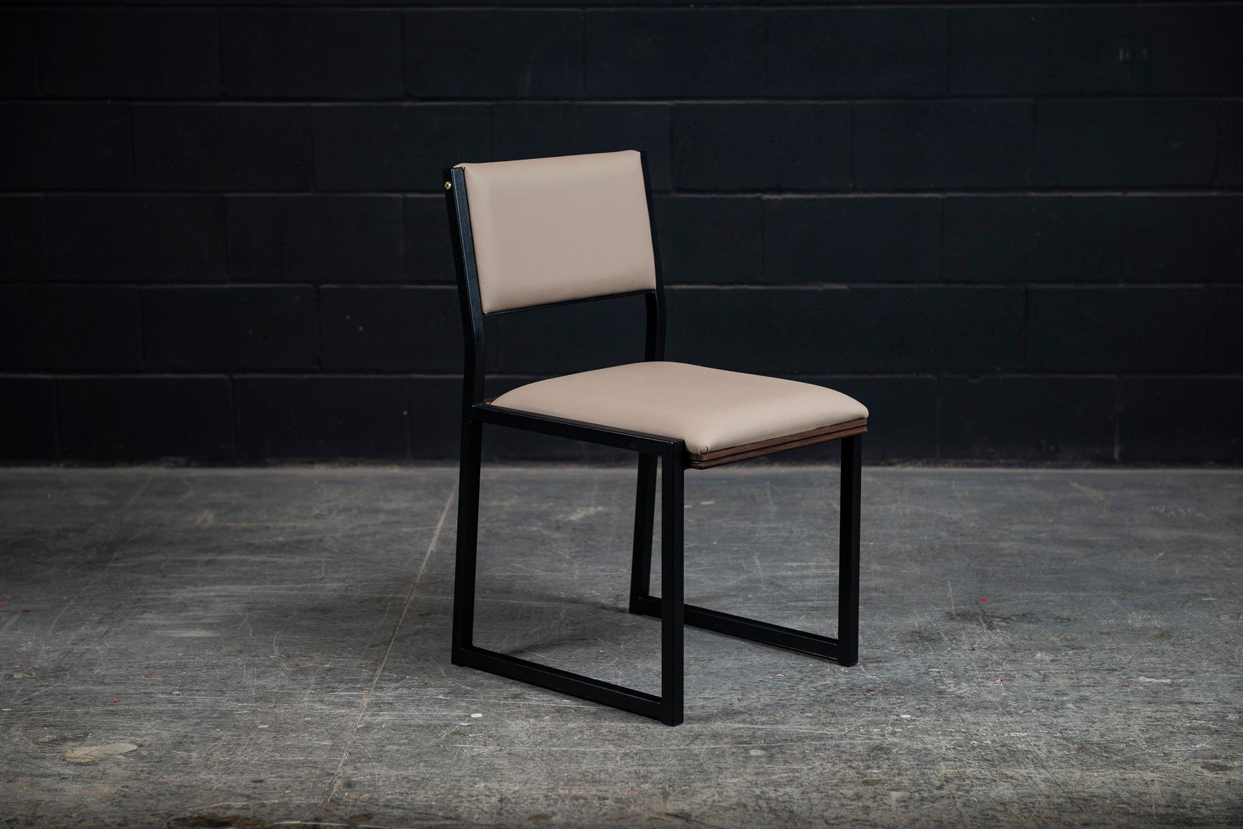 The Shaker modern dining chair is handmade to order from our unique Ambrozia black textured steel tubing frame. Available in a large variety of premium vinyls colors or leather in options. Also offered in COM or COL. Featuring subtitle solid wood