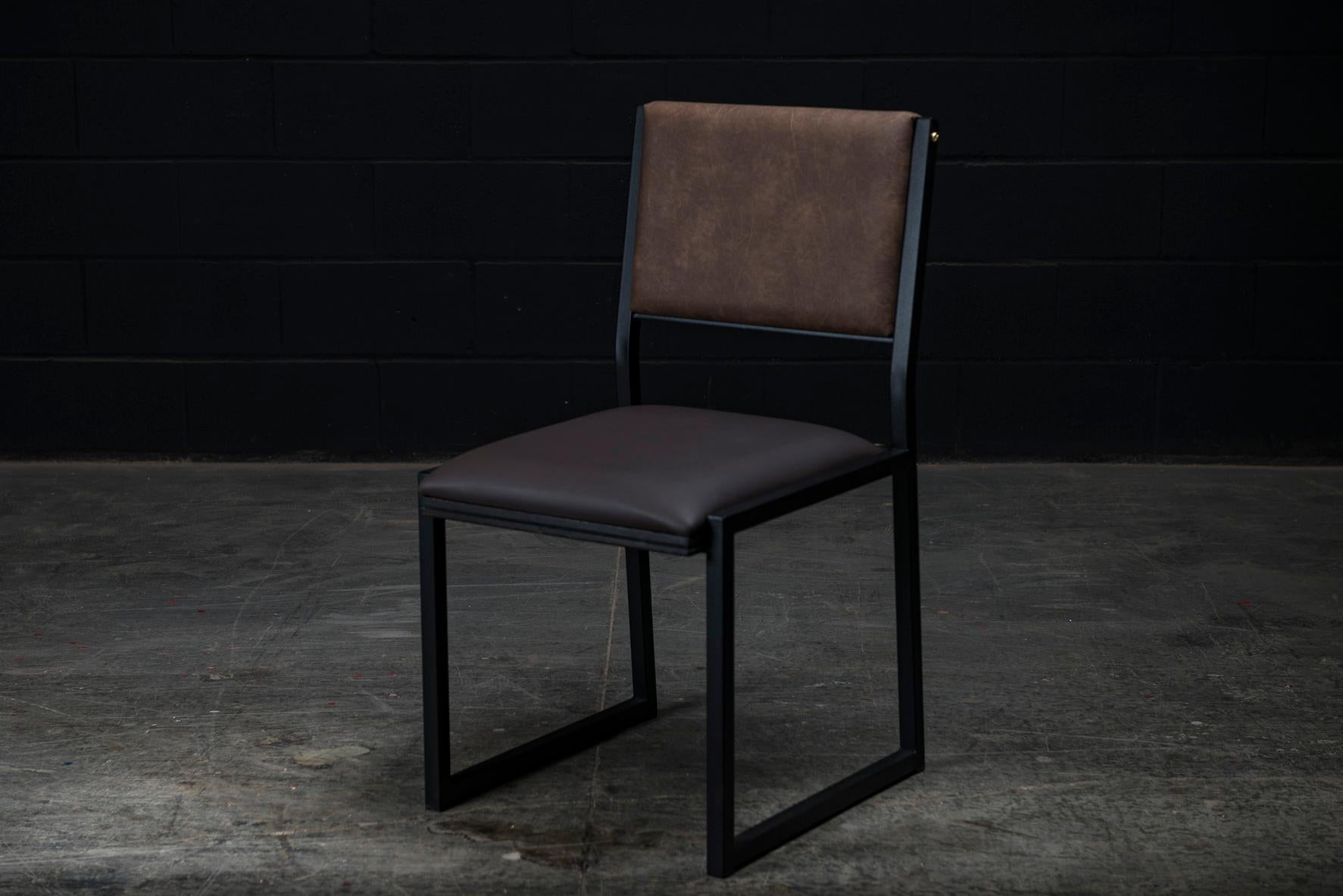 The Shaker modern dining chair is handmade to order from our unique Ambrozia black textured steel tubing frame. Available in a large varieties of Premium Vinyls or Genuine Leather in option. Also offered in COM or COL for seat and backrest.