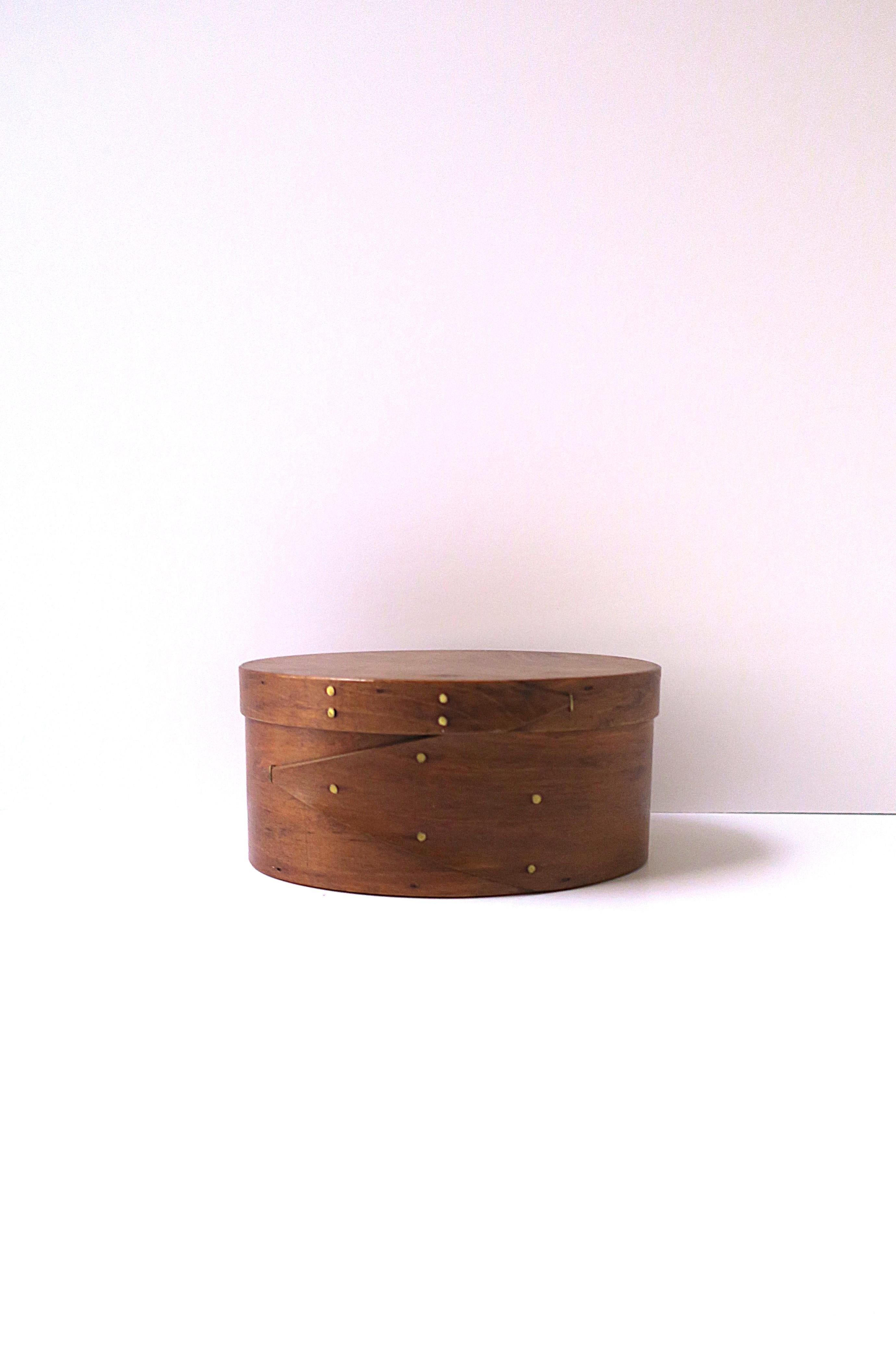 A beautiful, finely crafted bentwood cedar Shaker style storage or decorative box, circa late-20th century, American. Box is a rich brown cedar wood tacked with hand forged brass nails. A great piece for display or storage (demonstrated.) Very good