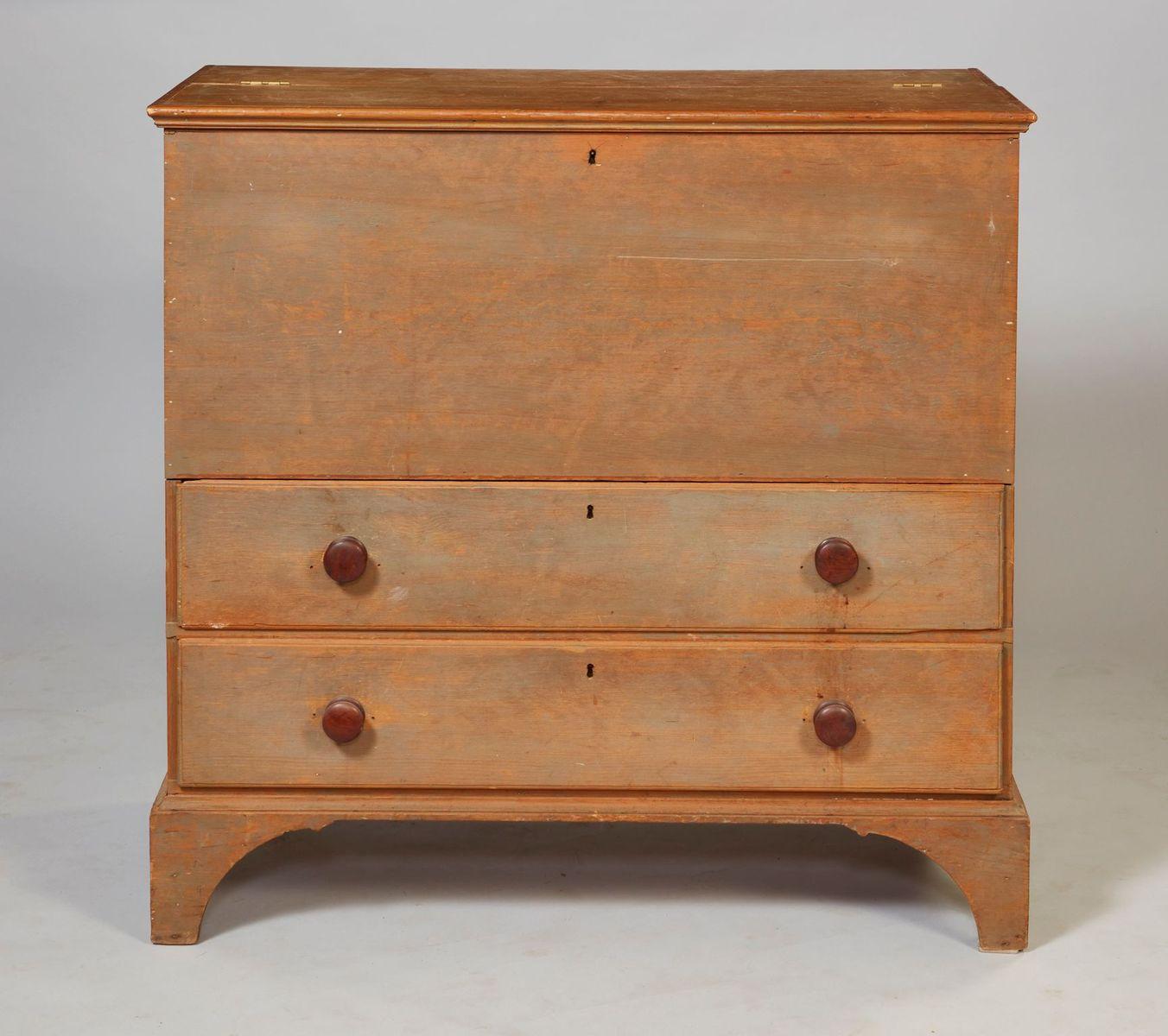 American early 19th century painted two drawer blanket chest with double hinged lid with ogee molded edge over simple case with two drawers having large turned walnut knobs and standing on simple but sculptural arched bracket feet, the whole