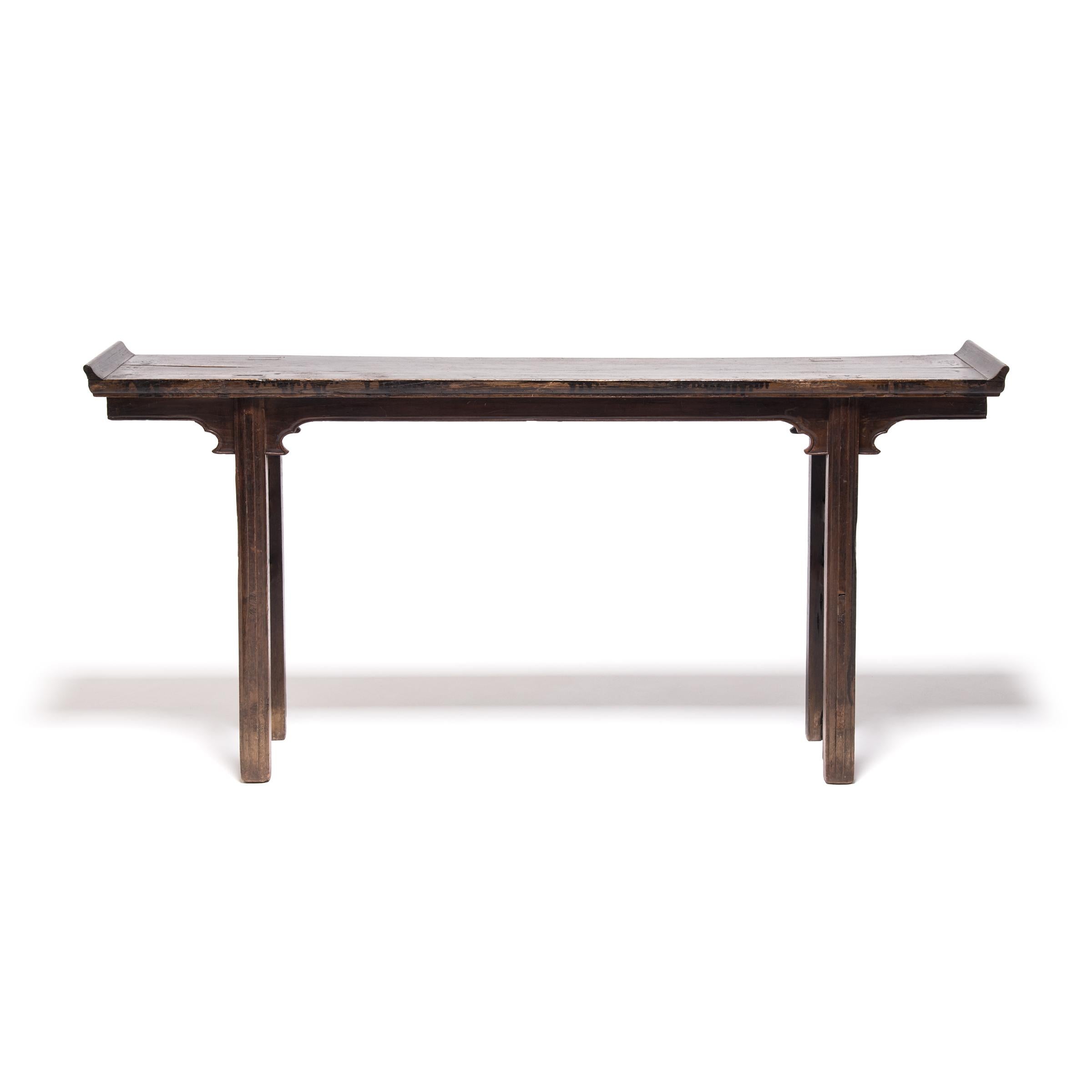 A century and a half ago this elm wood table probably sat in the home of a Qing Dynasty family, used as their ancestral altar. The clean lines would have complimented the Classic Chinese architecture of the home, but the elegant simplicity makes