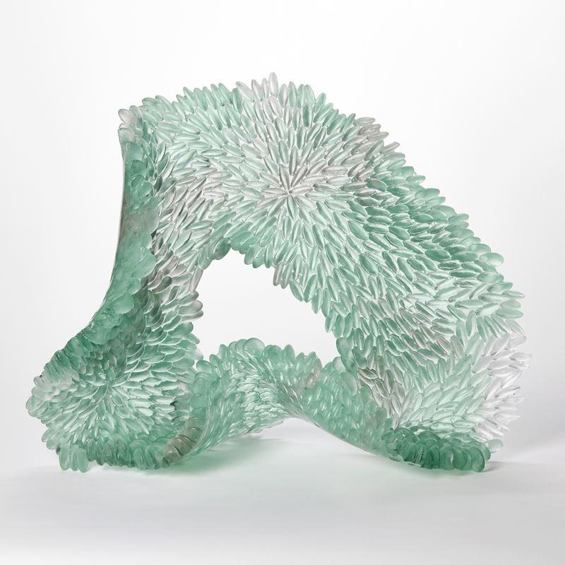 'Shallow Water II' is a unique glass sculpture by the British artist, Nina Casson McGarva.

Casson McGarva firstly casts her glass in a flat mould where she introduces all of the beautifully detailed, scaled surface texture, all unique and to her