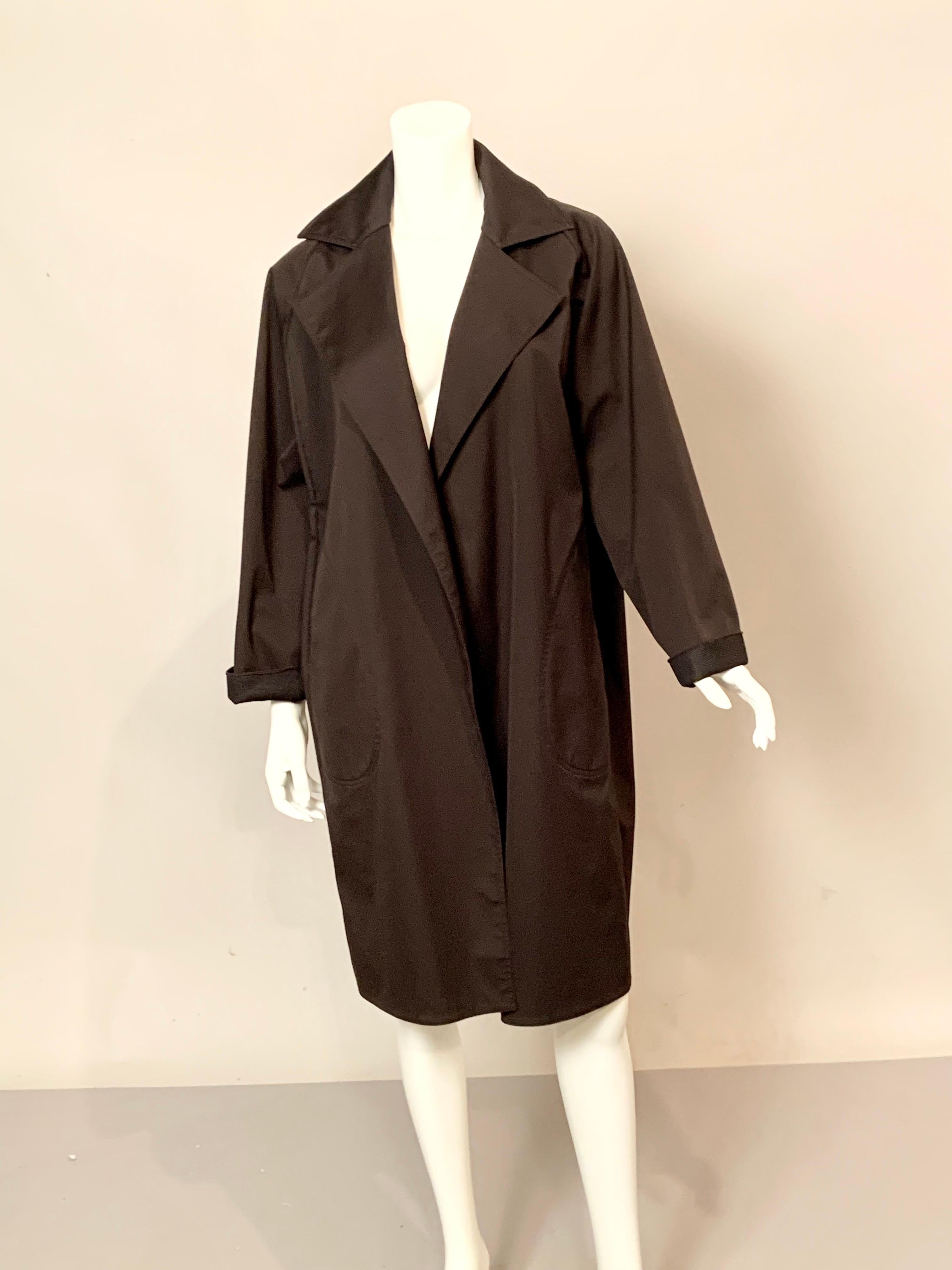 Ronaldus Shamask has designed the perfect raincoat, light enough for a Spring shower and roomy enough to layer for a winter downpour.  The coat is spare of decoration with two generous pockets in the shape of raindrops.  The coat is in excellent