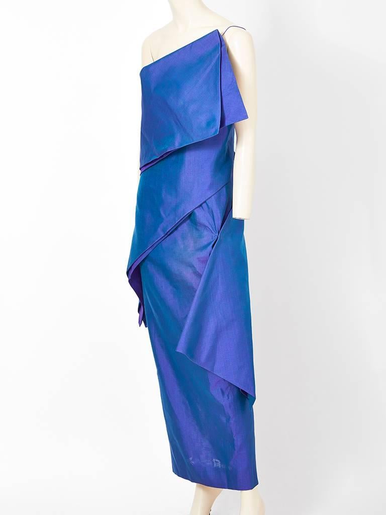 Ronaldus Shamask, iridescent,  blue, silk and cotton combination, long one shoulder dress having 2 diagonally placed wide tiers that wrap around the dress having a sculpted 