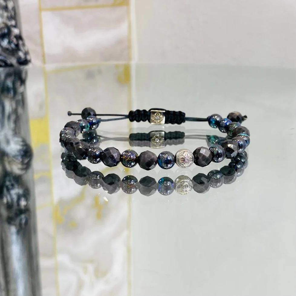 Shamballa Jewels Bracelet 18k White Gold with Opal & Sapphire 

18k white gold main bead with Shamballa logo and central diamond. Square white gold closure bead also having a diamond. Consisting of 10 facetted brown Sapphires and 13 Boulder