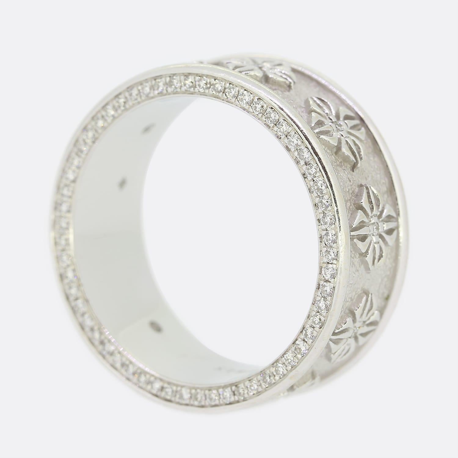 This is a diamond eternity band ring. The ring was made by the famous jewellery company Shamballa Jewels. It has been set with an array of round brilliant cut diamonds in an 18ct white gold setting. Additionally, both sides of the ring have been set