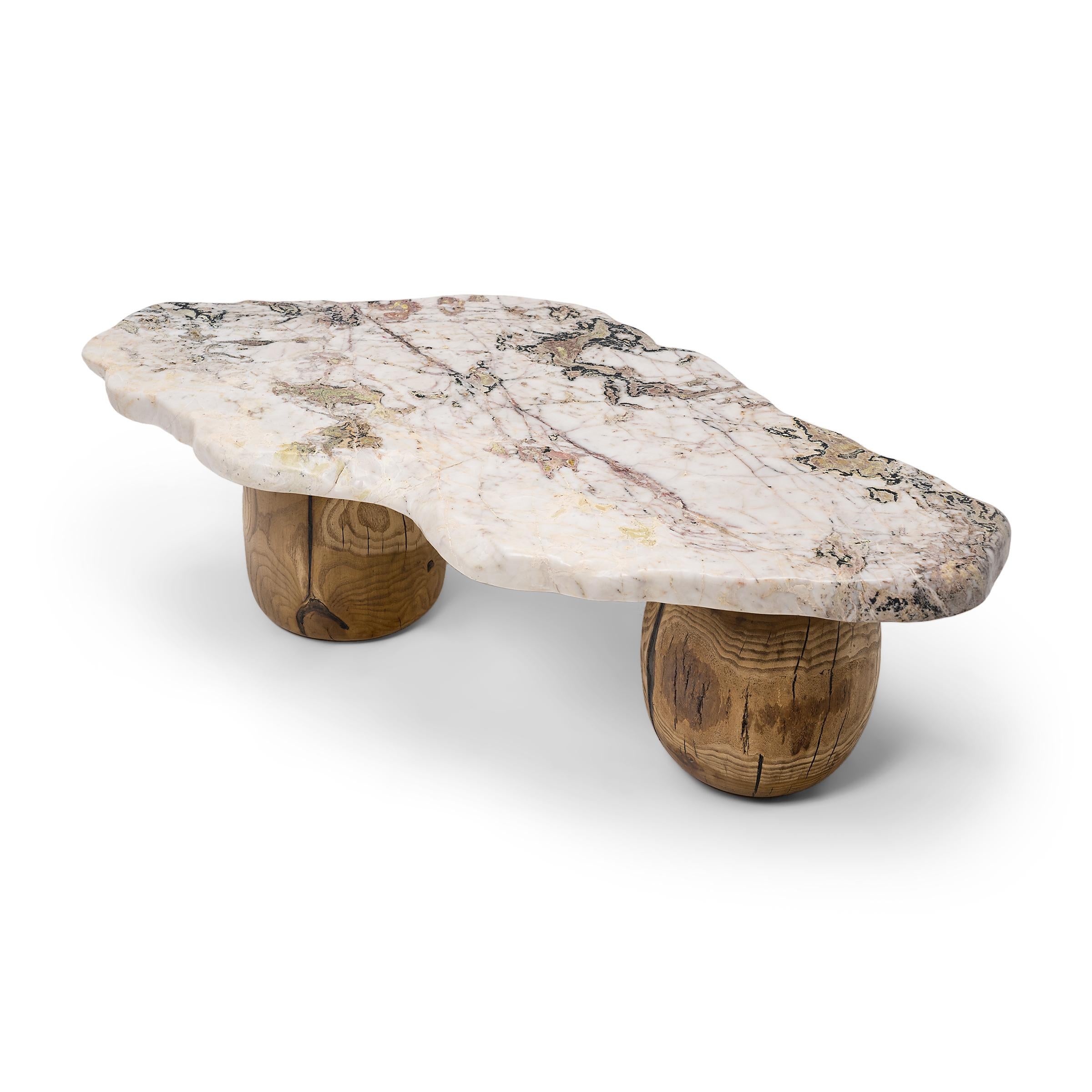 This meditation stone coffee table exemplifies organic modern style with an emphasis on natural materials. The tabletop is solid stone unearthed from Jiangsu province, comprised of white marble with mineral inclusions of pink, black and light green.