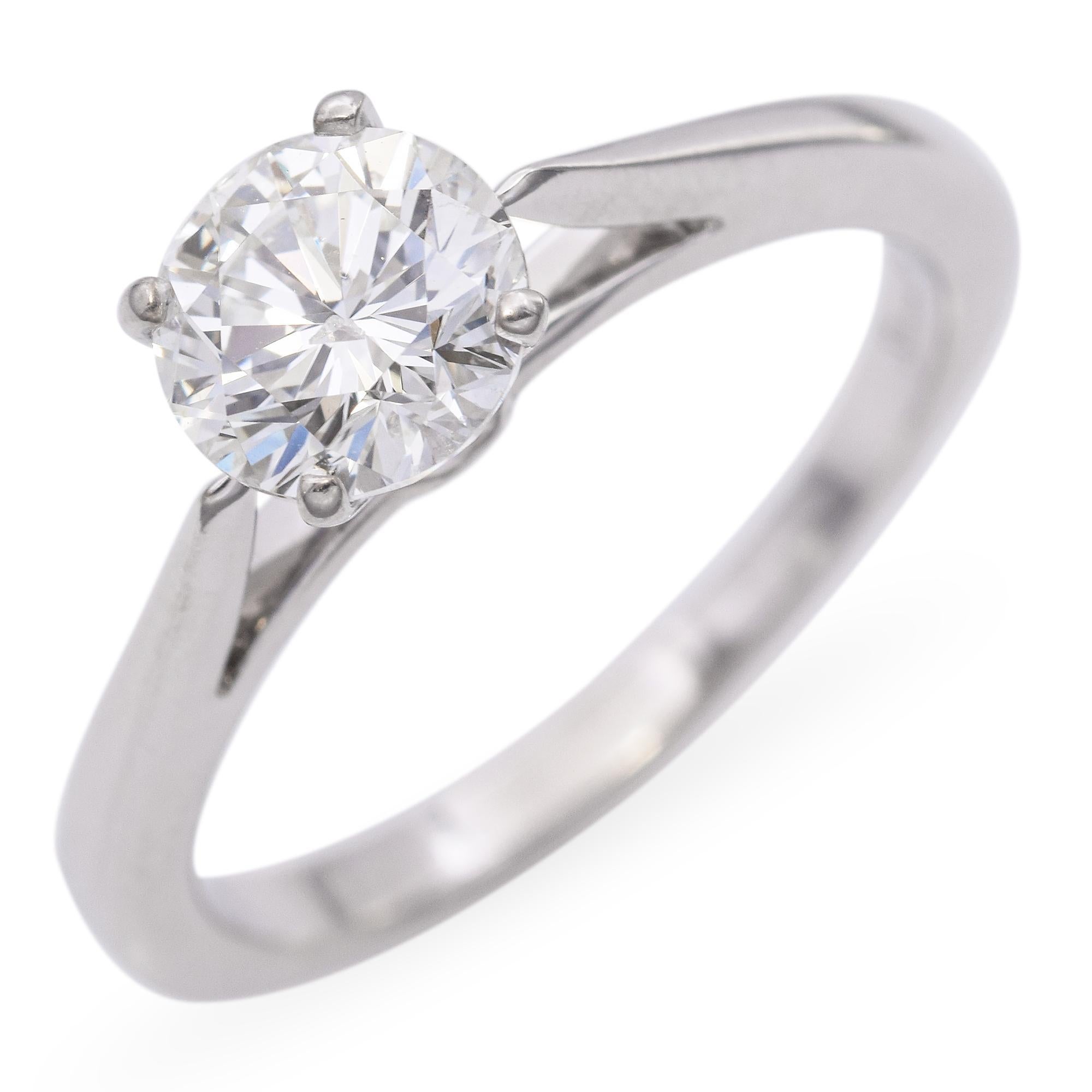 Elegant Solitaire White Gold Diamond Engagement Ring. This exquisite ring is crafted in 14k white gold. The center features a stunning round diamond, set in a classic solitaire design that highlights its brilliance. The band is smooth and polished,