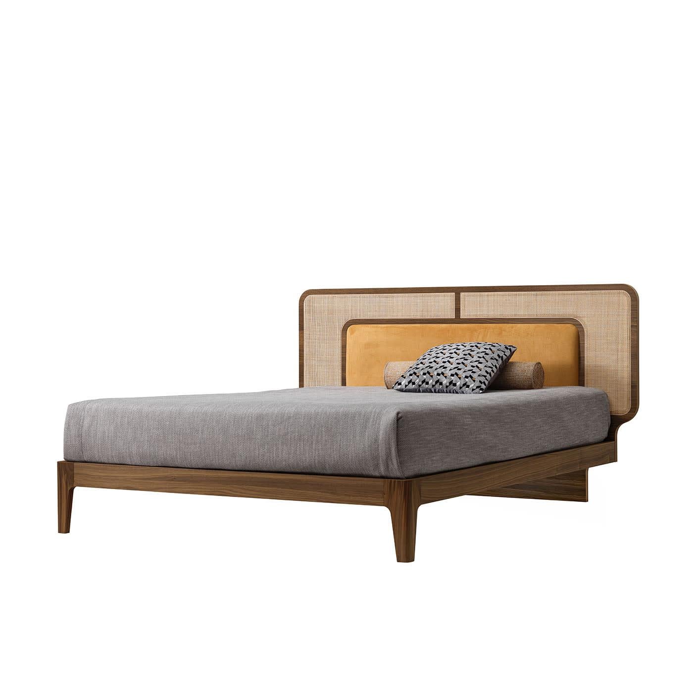 This double bed is a clever combination of silhouettes and textures. The sturdy Canaletto walnut structure, enhanced with Havana stain, also comprises the rounded profiles encircling the headboard, where Vienna straw embraces an insert of
