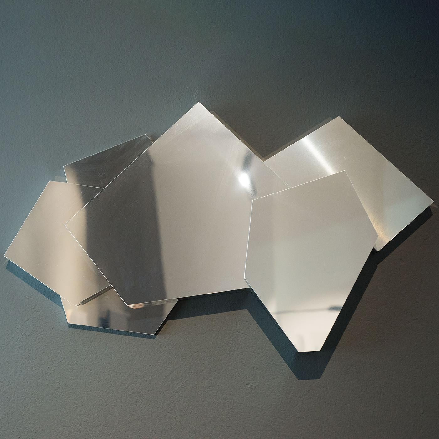 This distinctive and unique mirror features an irregular shape crafted of form-folded supermirror stainless steel with a high-gloss, polished, and reflective surface. A sophisticated and ultramodern objet d'art which will make an impression in a