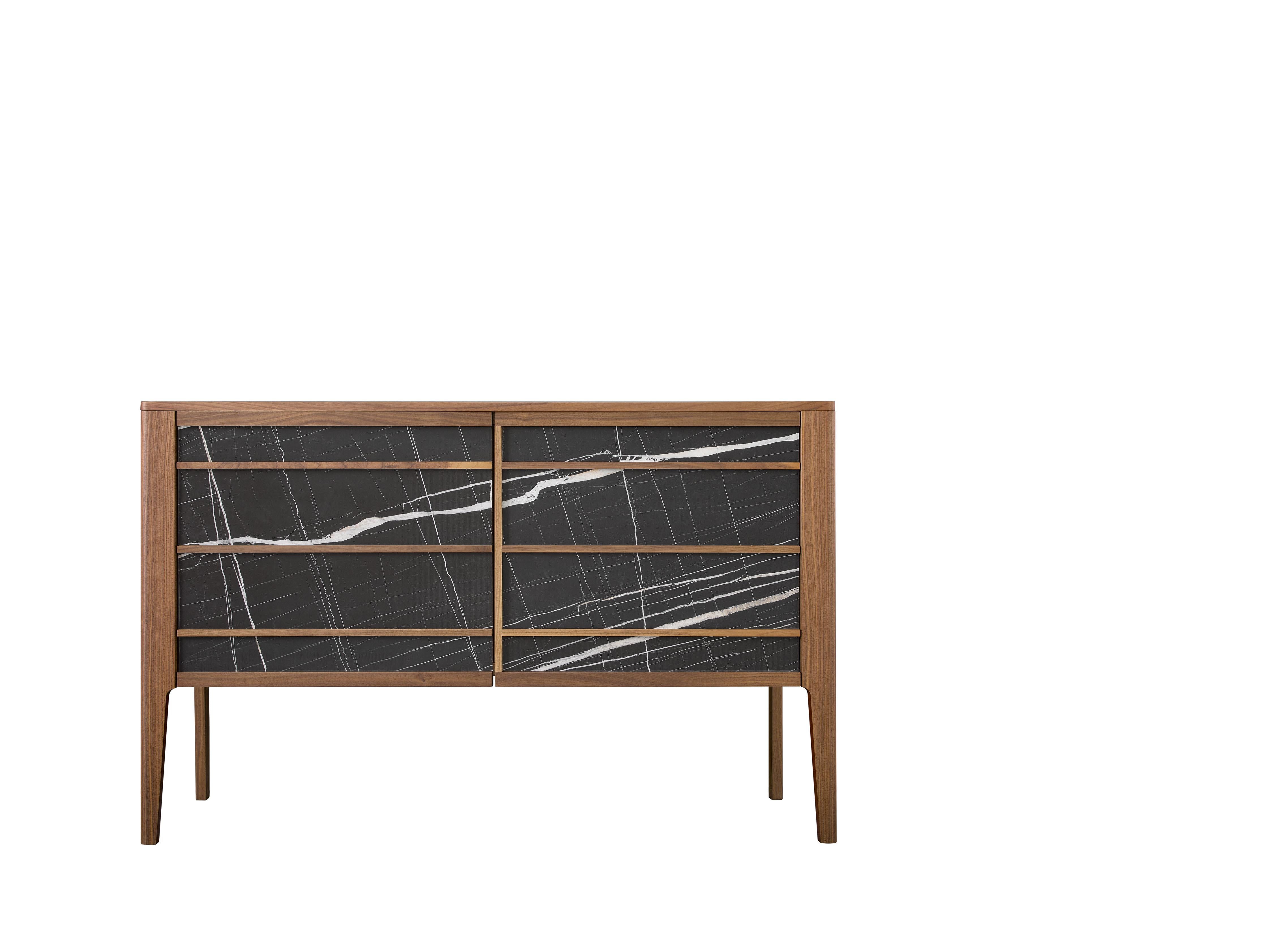 This elegant sideboard features 2 wooden doors with a Sahara Noir Marble front that complements the Havana finish structure. The integrated wooden handles hide 2 glass shelves.
