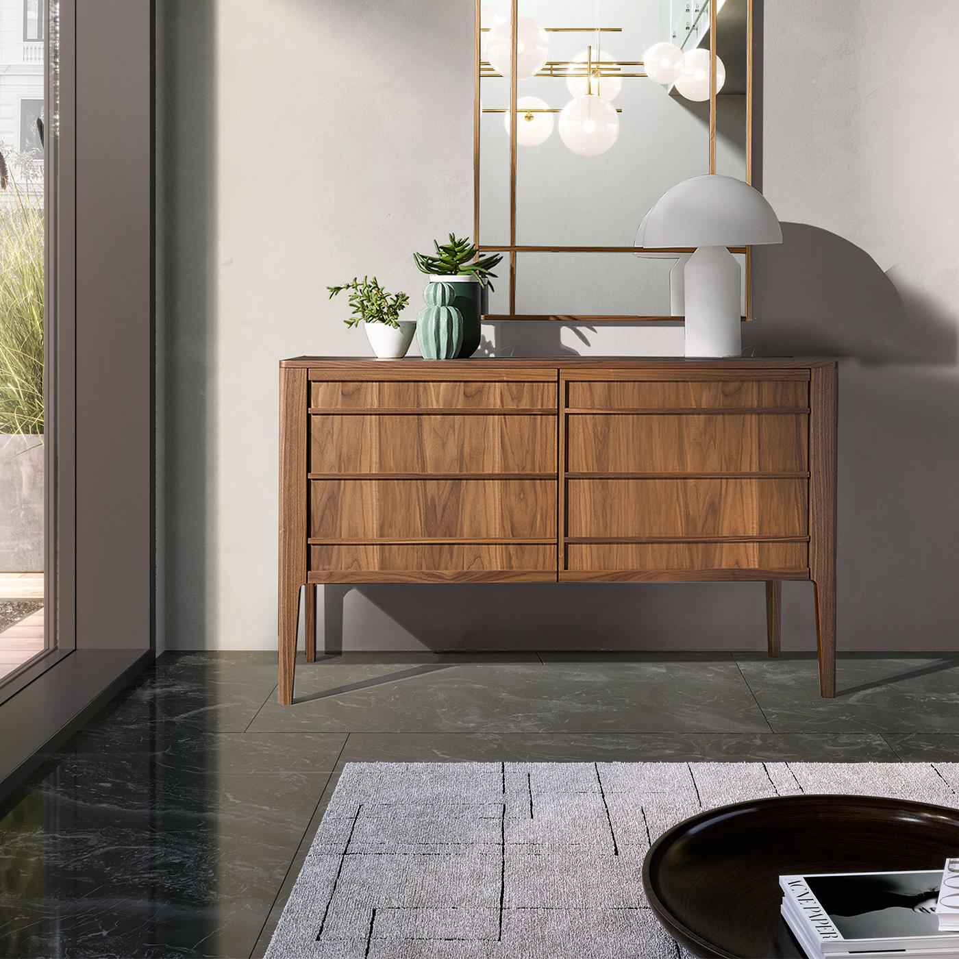 This sideboard features 2 wooden doors and 2 glass shelves with integrated wooden handles in a natural Havana finish.
