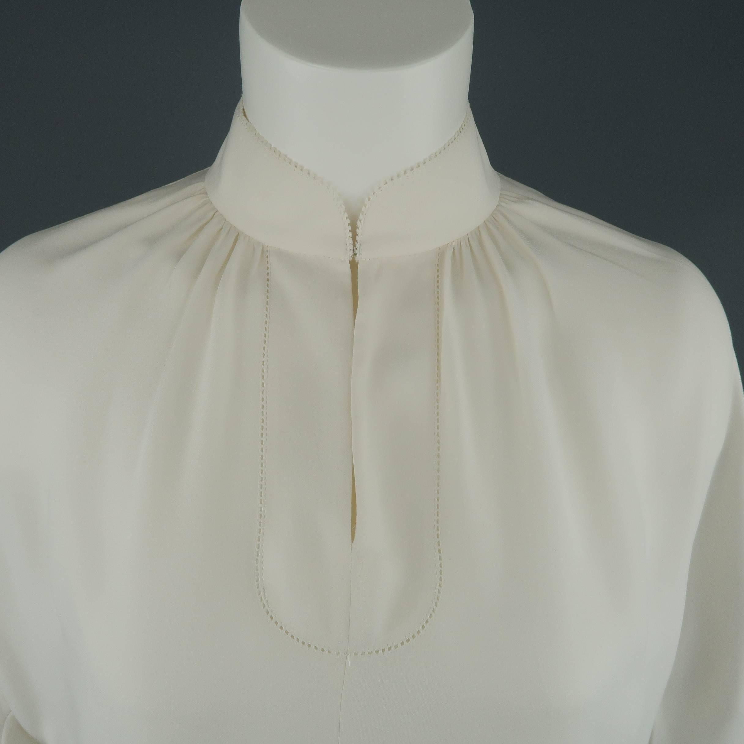 SHANGHAI TANG tunic comes in white silk with a Mandarin collar, gathered top, A line silhouette, and lace trim three quarter sleeves.
 
Excellent Pre-Owned Condition.
Marked: 6
 
Measurements:
 
Shoulder: 16 in.
Bust: 46 in.
Sleeve: 20 in.
Length: