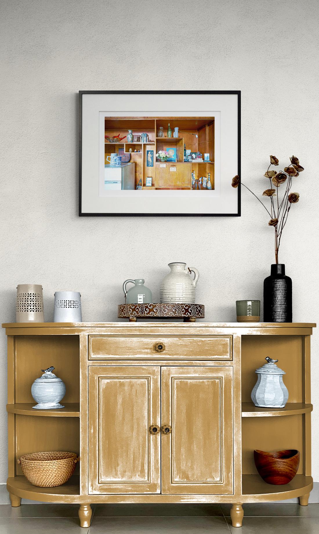 Shani Mootoo’s nostalgic images of her childhood home in Trinidad reveal an intimate and compelling story. Her ‘History Revisited’ series—photographs of interior rooms, furniture and trinkets are portraits of a life. This wood wall cabinet contains