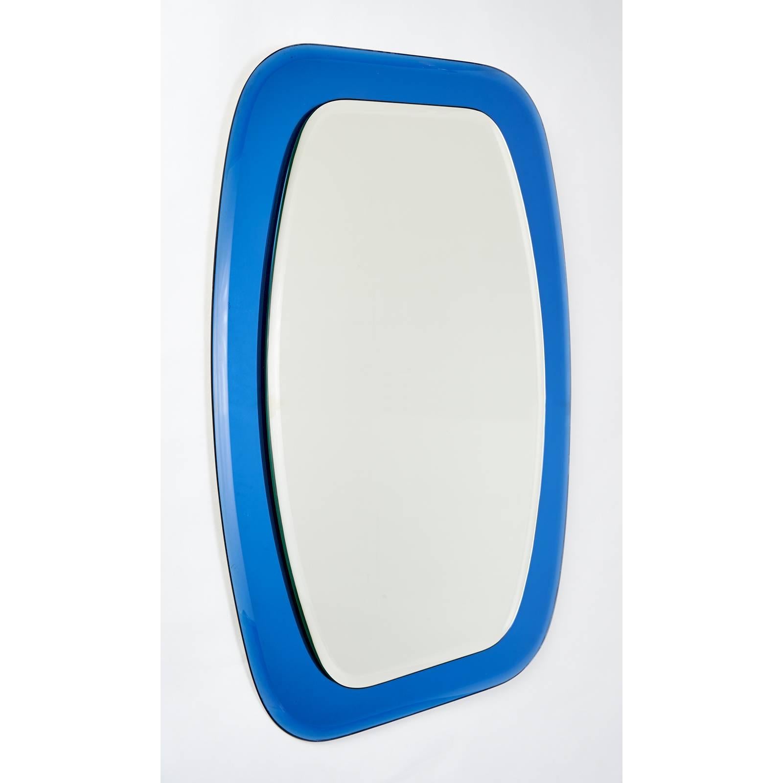 Italy, 1970s
Shaped beveled mirror
Mounted on a shaped beveled blue mirrored glass frame
Measures: 23 W x 32 H.

