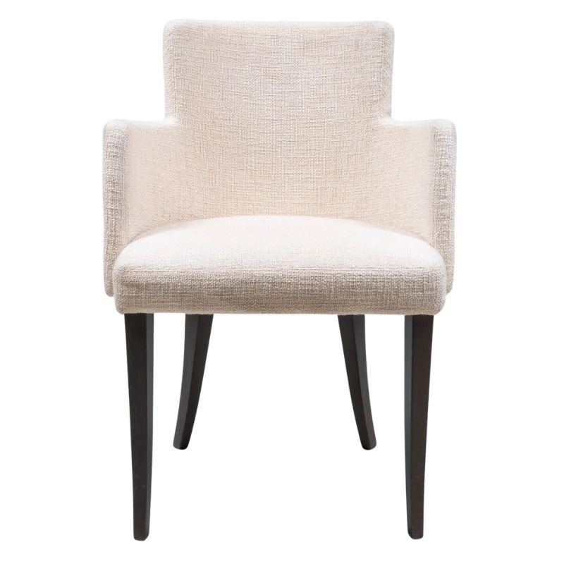 A shaped contemporary style arm chair upholstered in heavyweight off-white linen with slender stained wood legs.