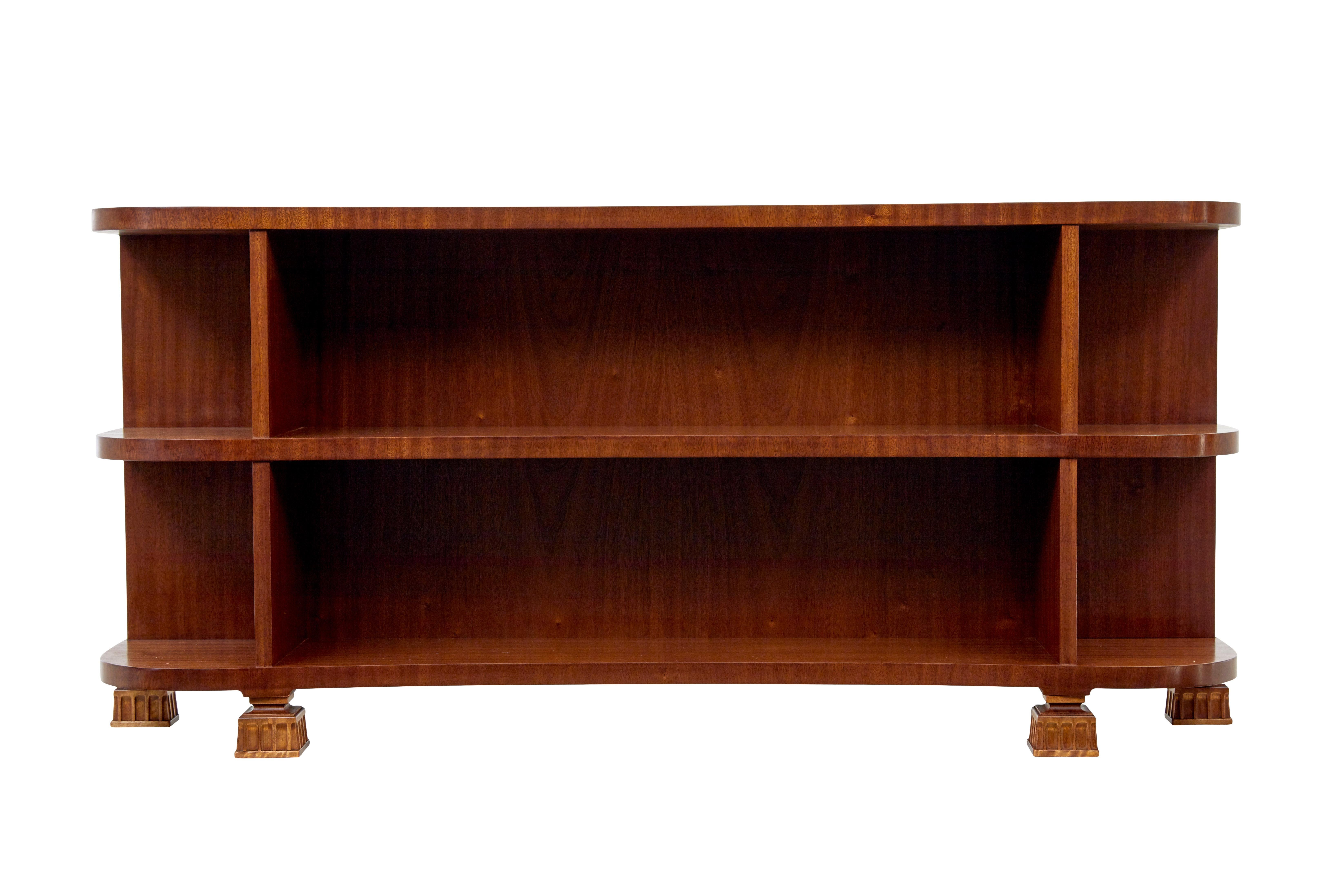 Shaped mid century Scandinavian mahogany low open bookcase circa 1960.

Fine quality low open bookcase from Sweden.  Concave shaped top, which allows 6 open areas for book and display storage.  Rich colour and this piece has just been fully restored