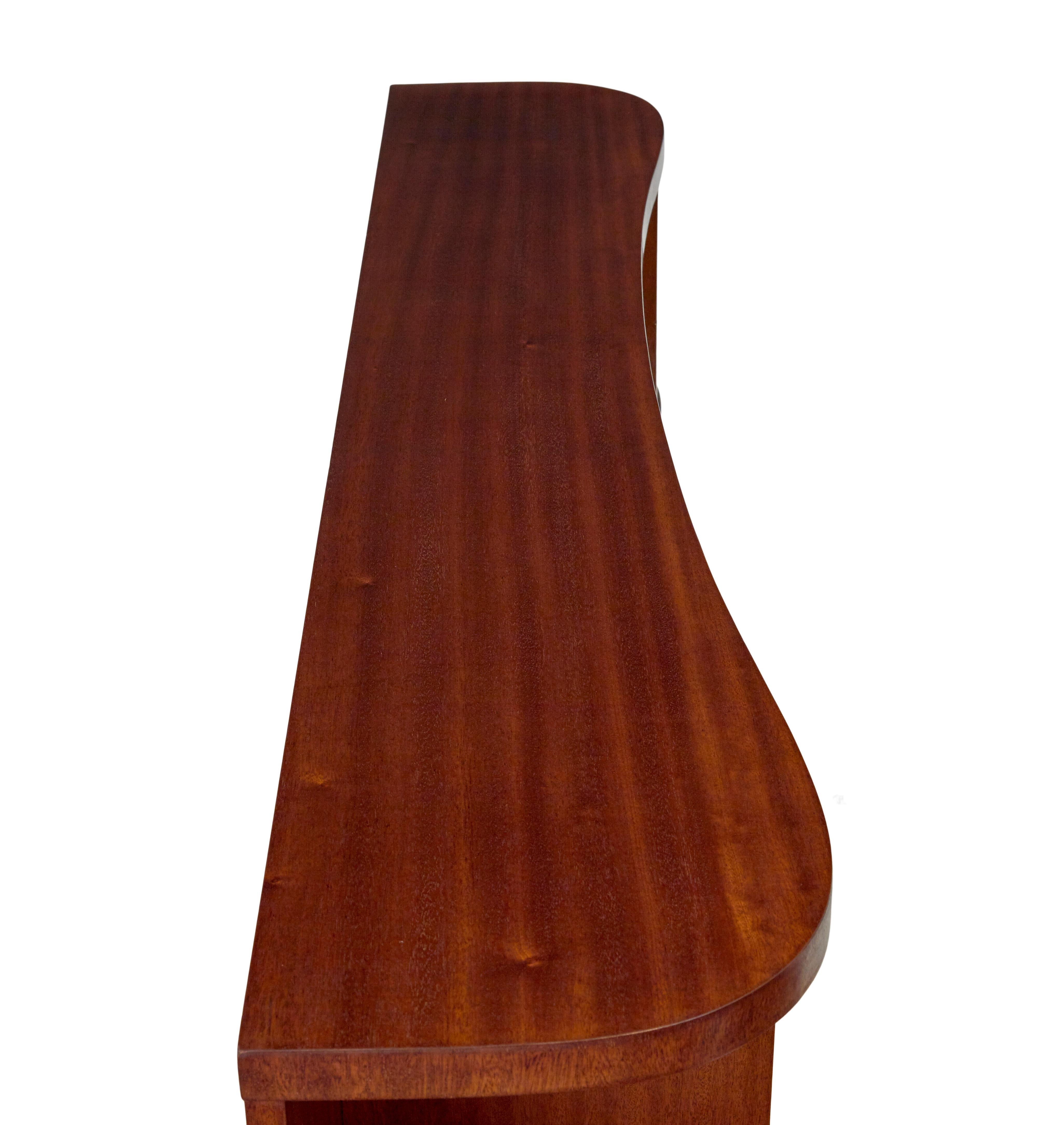 Shaped mid century Scandinavian mahogany low open bookcase In Good Condition In Debenham, Suffolk