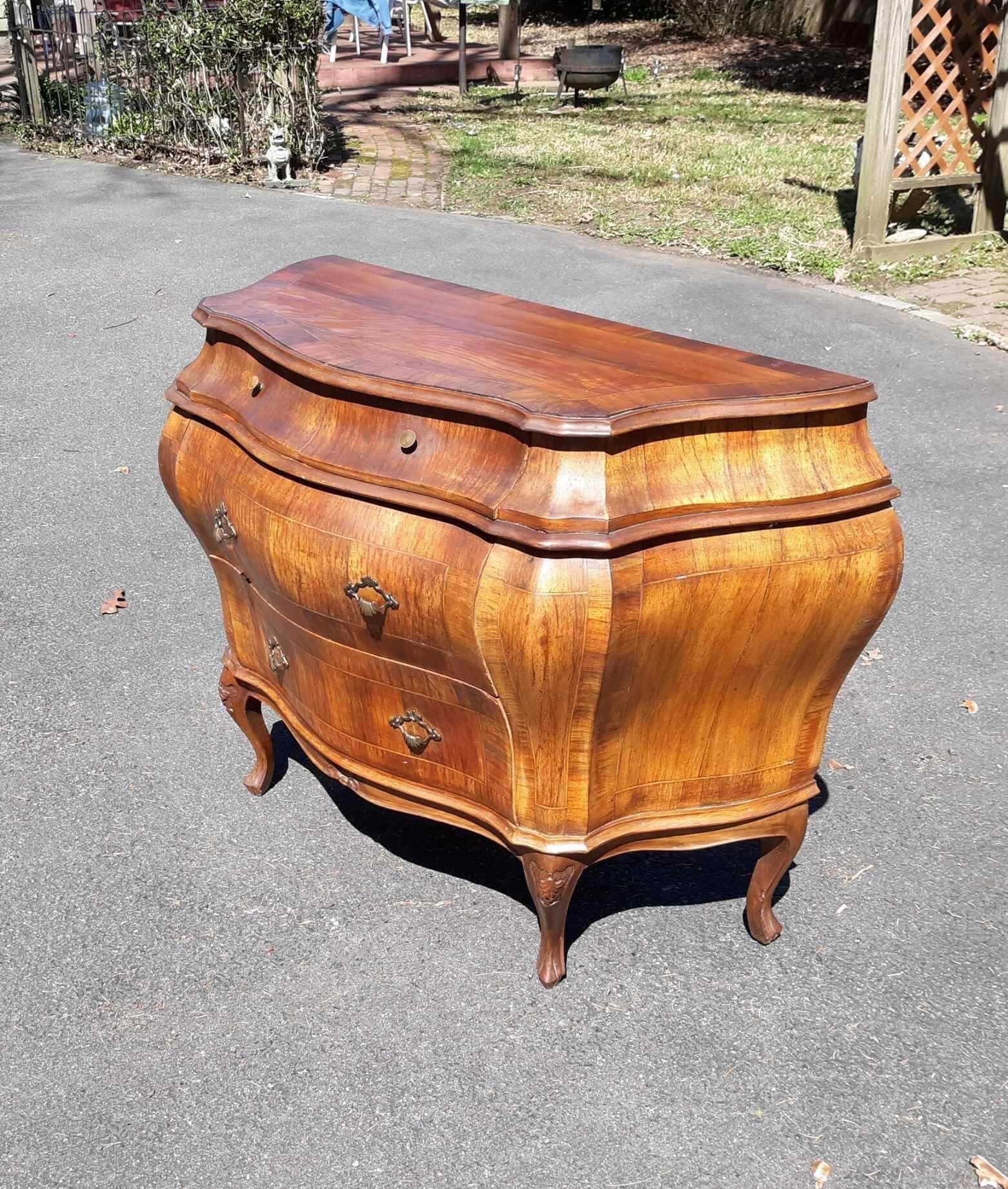 Chic Italian fruitwood bombe chest. The shapely form with three drawers with figural fruitwood grain.