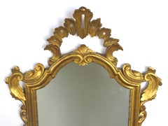 Shapely Italian Rococo Style Carved Giltwood Mirror with Openwork Rocaille Crest
