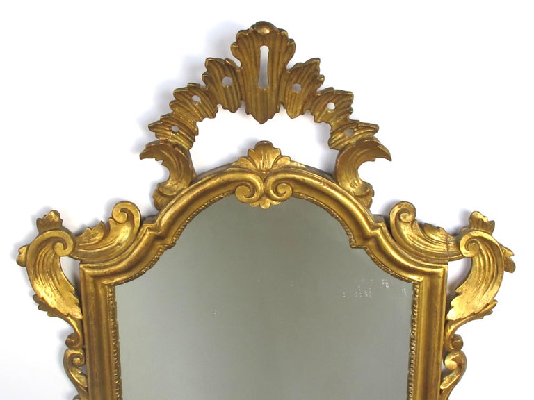 Shapely Italian Rococo Style Carved Giltwood Mirror with Openwork