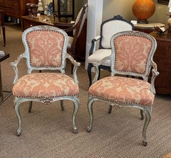 Shapely Pair of Italian Rococo Style Aqua Painted and Parcel-Gilt Armchairs