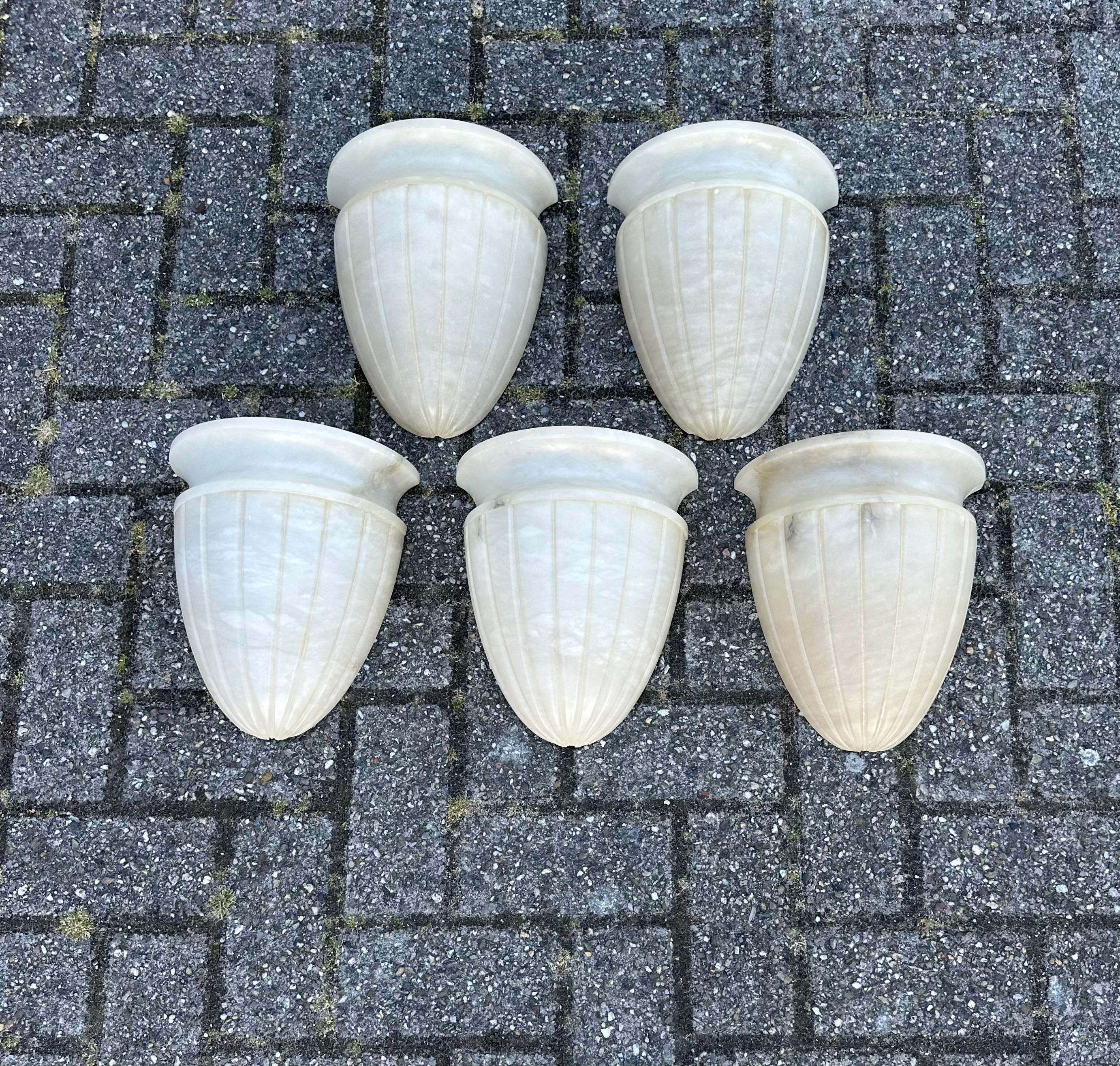 Set of five beautiful handcrafted wall lights.

If you are looking for a great shape and large size set of sconces to grace your living space then these natural mineral stone fixtures could be perfect. All handcrafted out of natural materials these