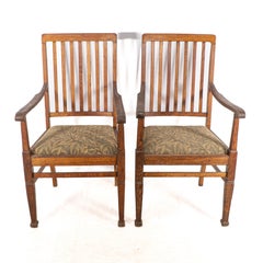 Shapland and Petter. A pair of Arts and Crafts oak armchair