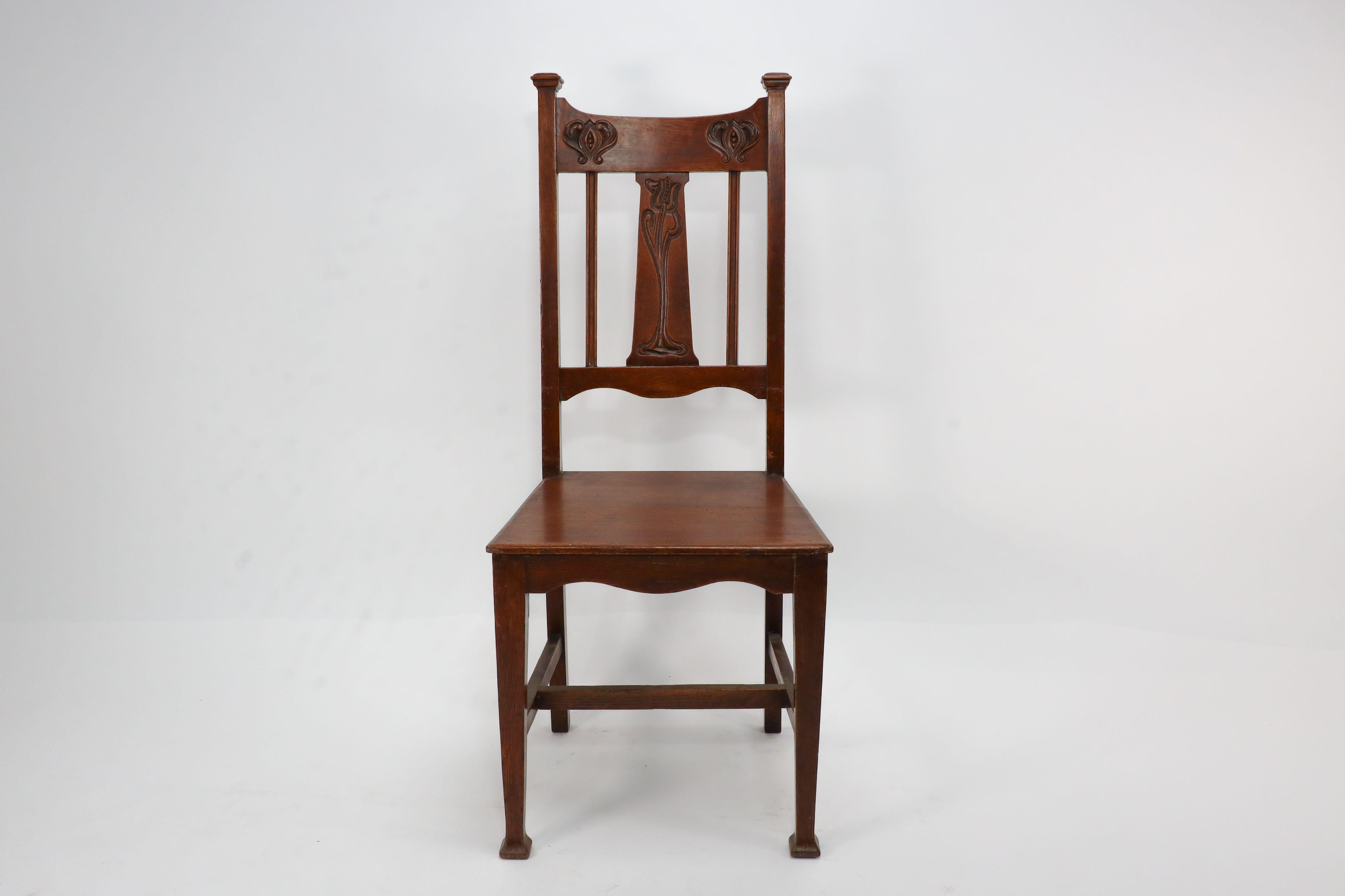 Shapland and Petter attributed, in the manner of M H Baillie Scott. A Glasgow School Arts and Crafts oak hall chair with stylized floral carving to the back.