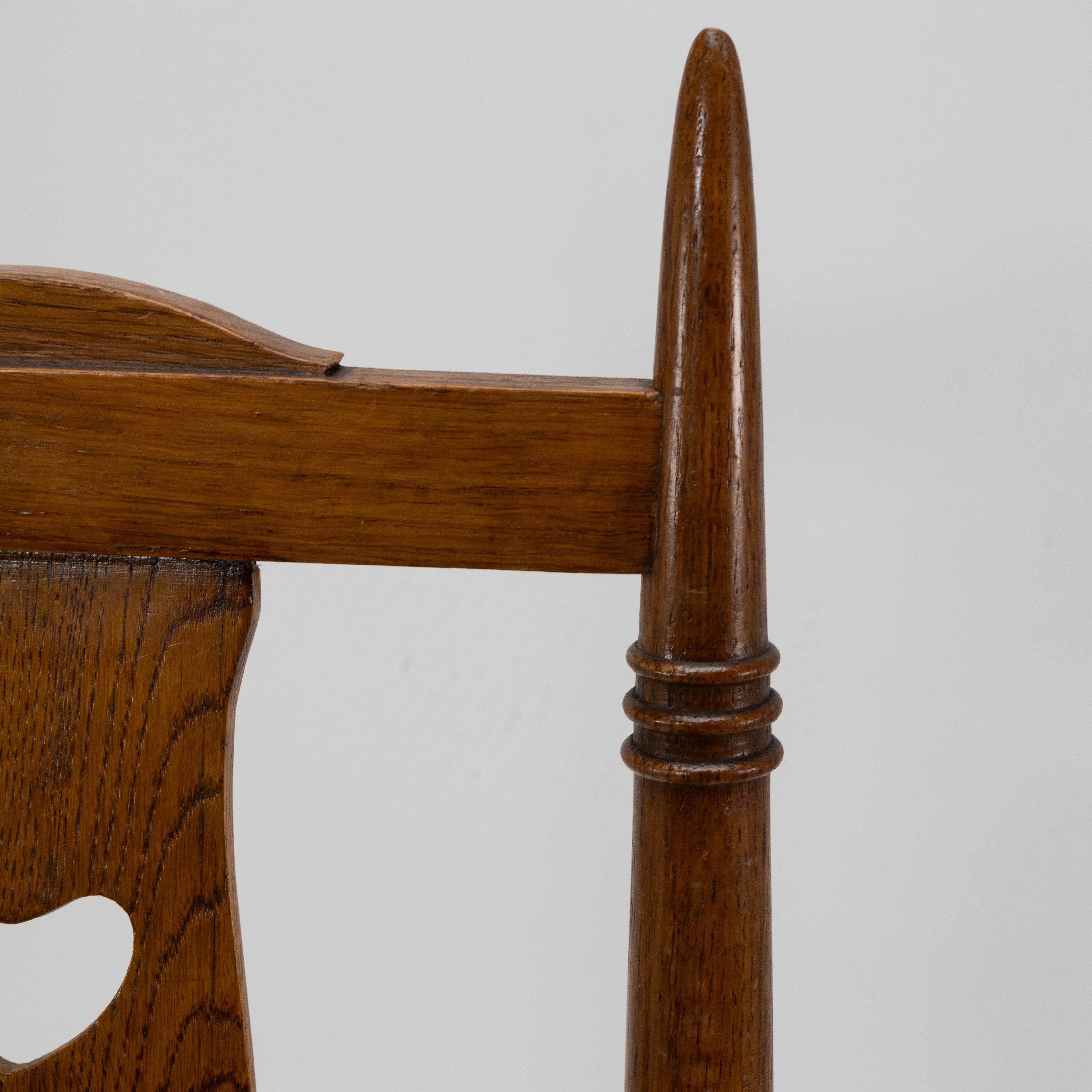 20th Century Shapland & Petter a Pair of Arts & Crafts Oak Dining Chairs with Pierced Hearts For Sale