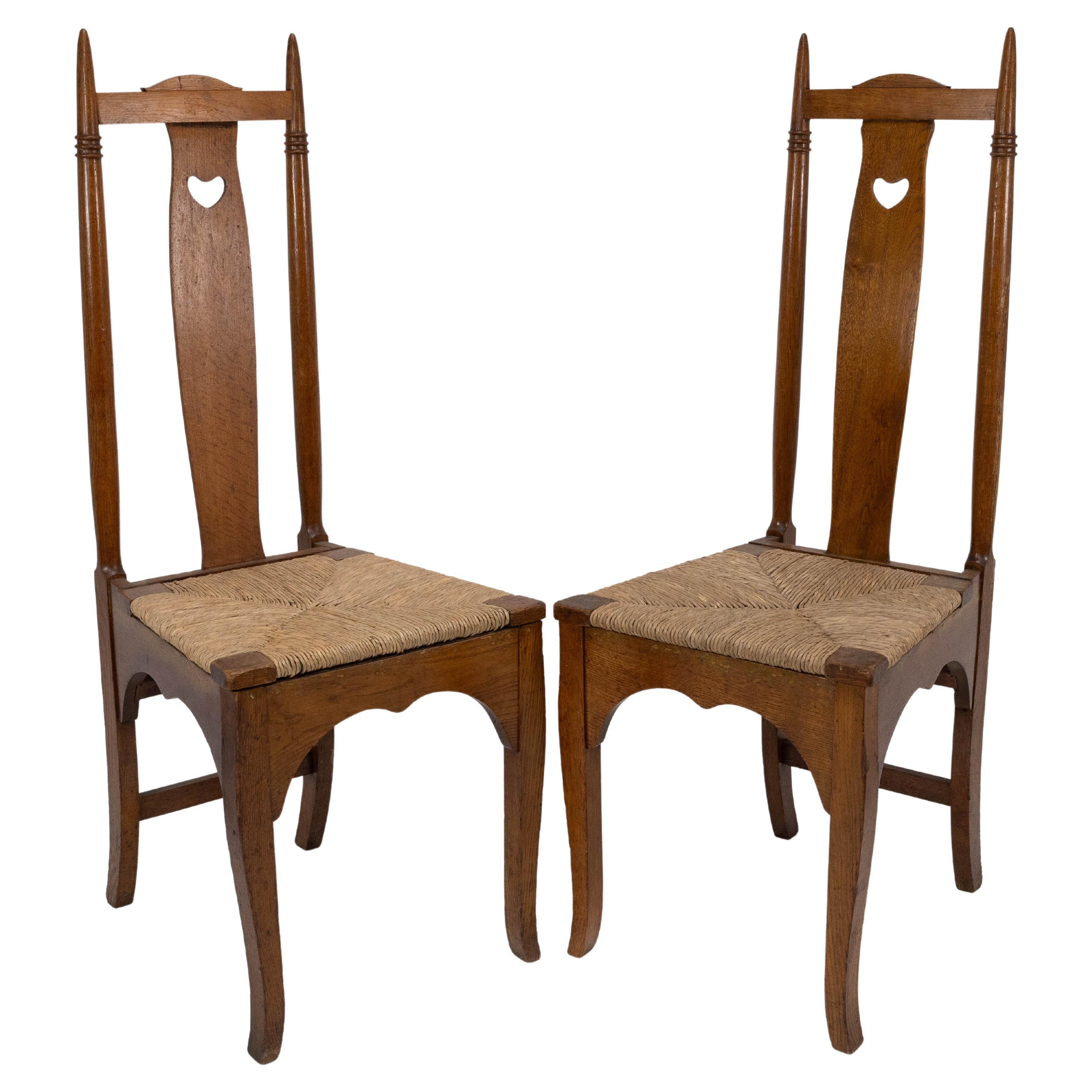 Shapland & Petter a Pair of Arts & Crafts Oak Dining Chairs with Pierced Hearts