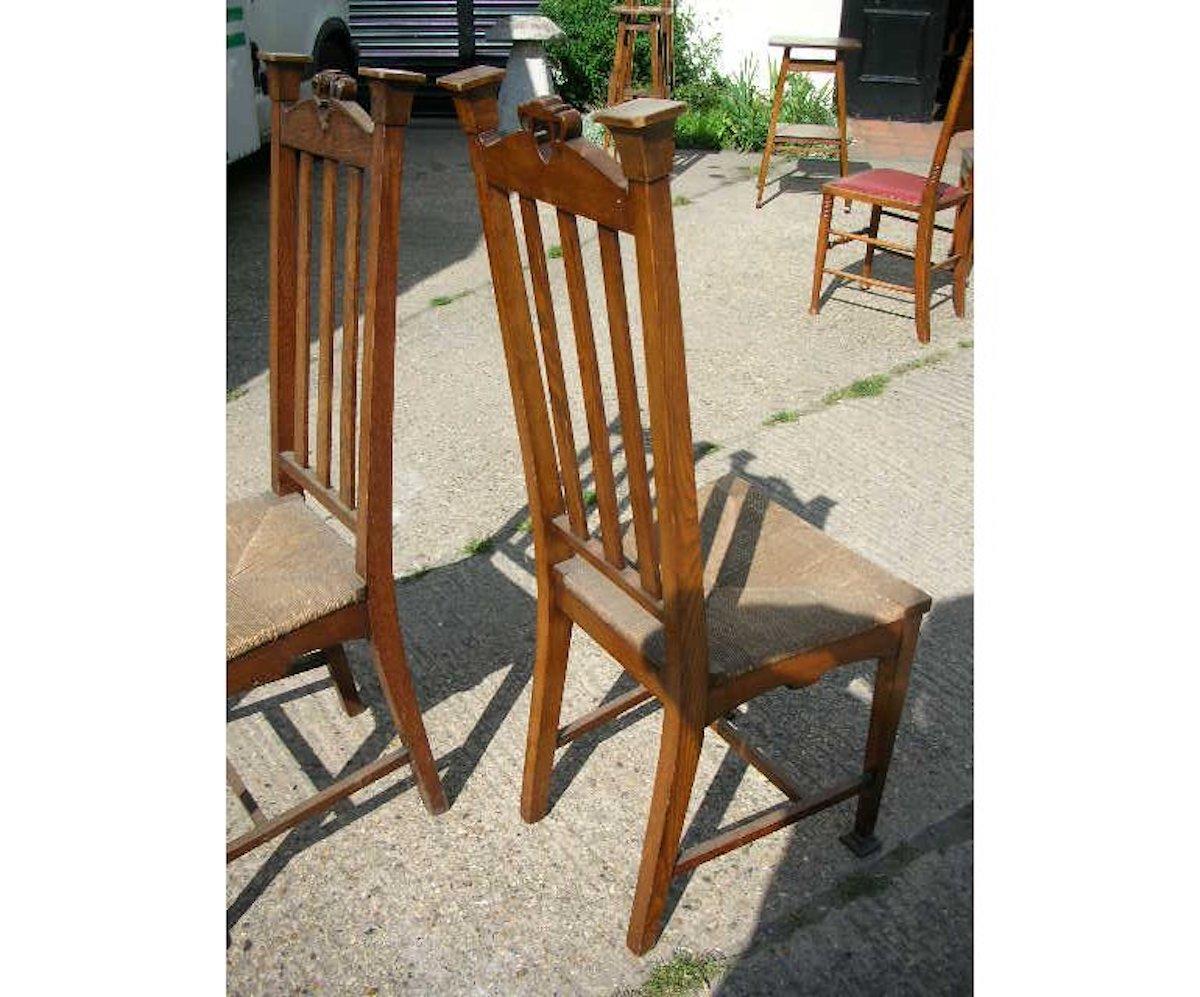 Shapland and Petter. Stamped with their design numbers under the seats.
An unusual pair of English Arts & Crafts Ash side chairs with heart-shaped open carvings to the tops.
Retaining the original rush seats in good condition.