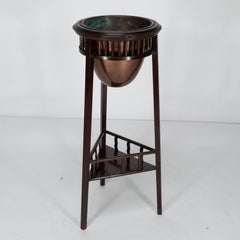 Shapland & Petter. A rare Arts & Crafts two tier walnut three leg plant stand