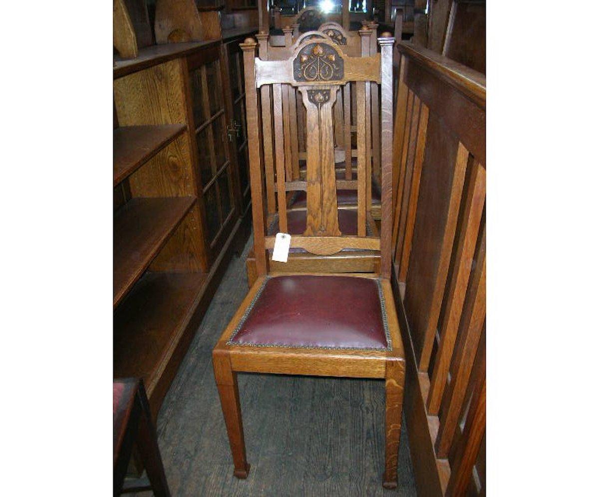 Shapland and Petter. A set of six Arts & Crafts dining chairs, consisting of four singles and two matching armchairs with stylised floral carving to the top and to the centre splat, on square tapering legs.
Measurements listed are for the four