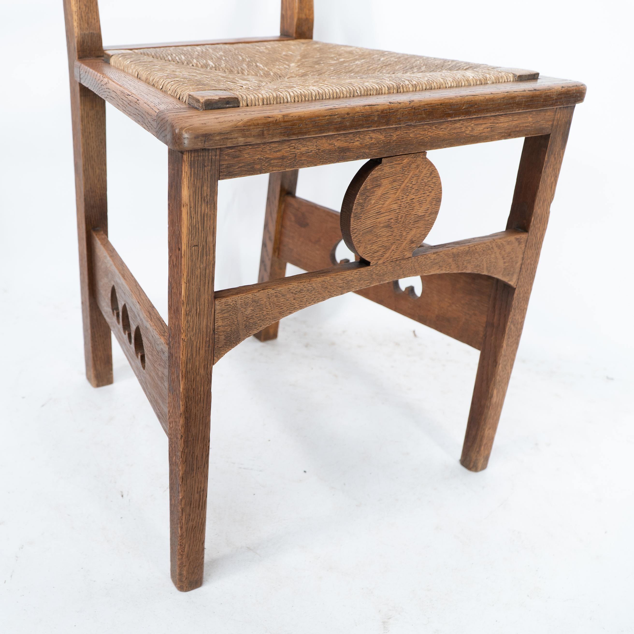 Shapland & Petter. An Arts & Crafts oak desk or side chair with pierced hearts For Sale 3