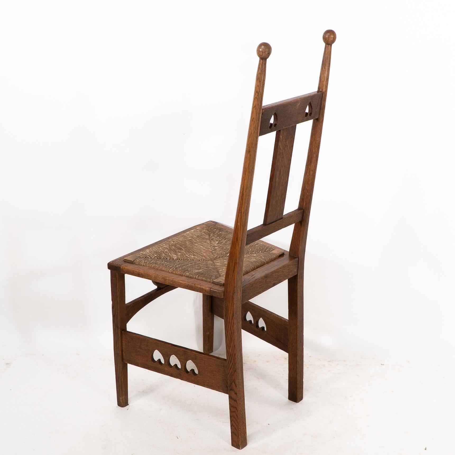 Shapland & Petter. An Arts & Crafts oak desk or side chair with pierced hearts For Sale 5