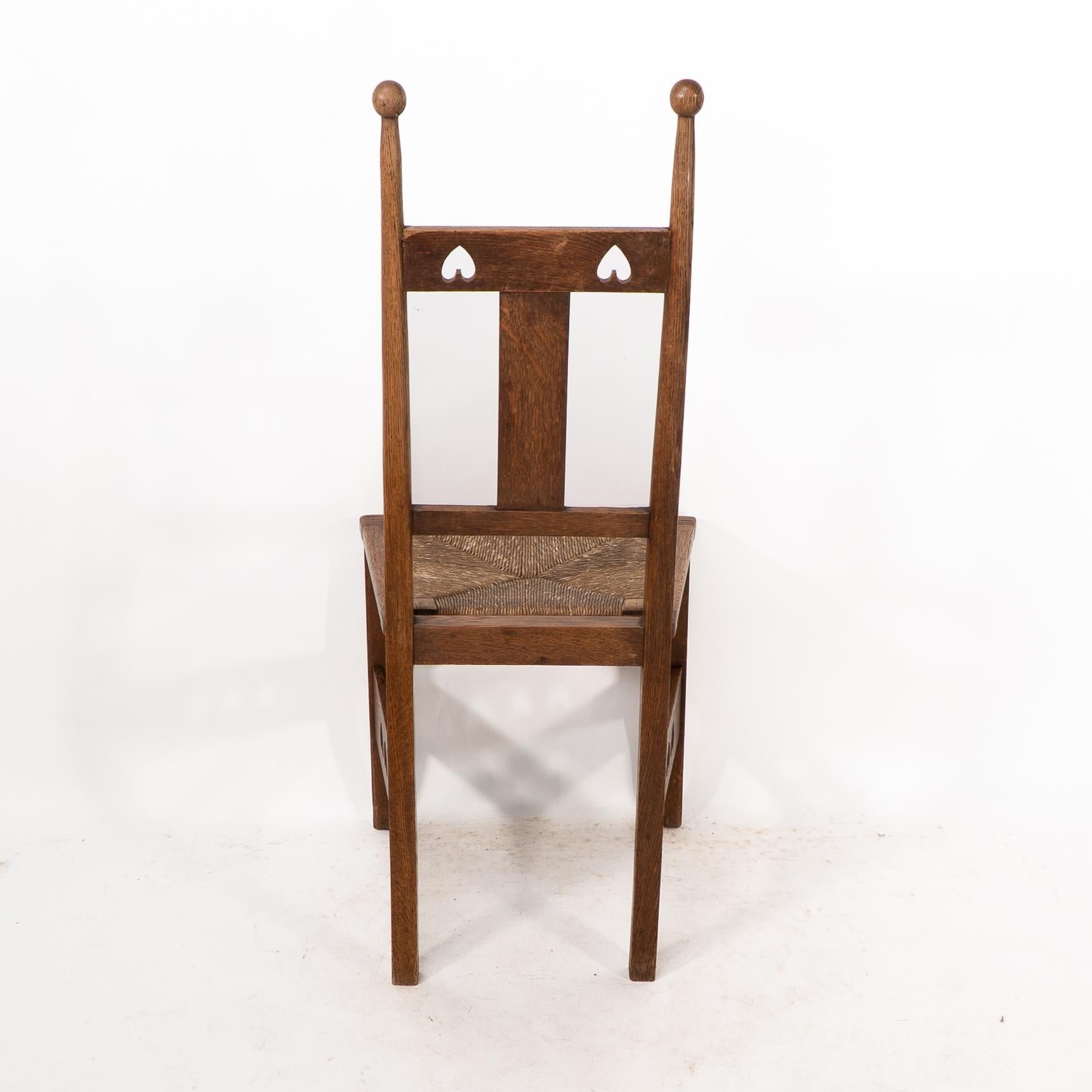 Shapland & Petter. An Arts & Crafts oak desk or side chair with pierced hearts For Sale 6