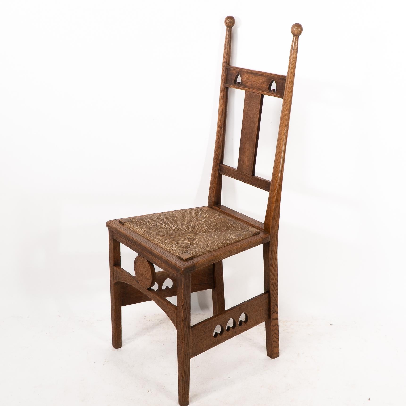 English Shapland & Petter. An Arts & Crafts oak desk or side chair with pierced hearts For Sale