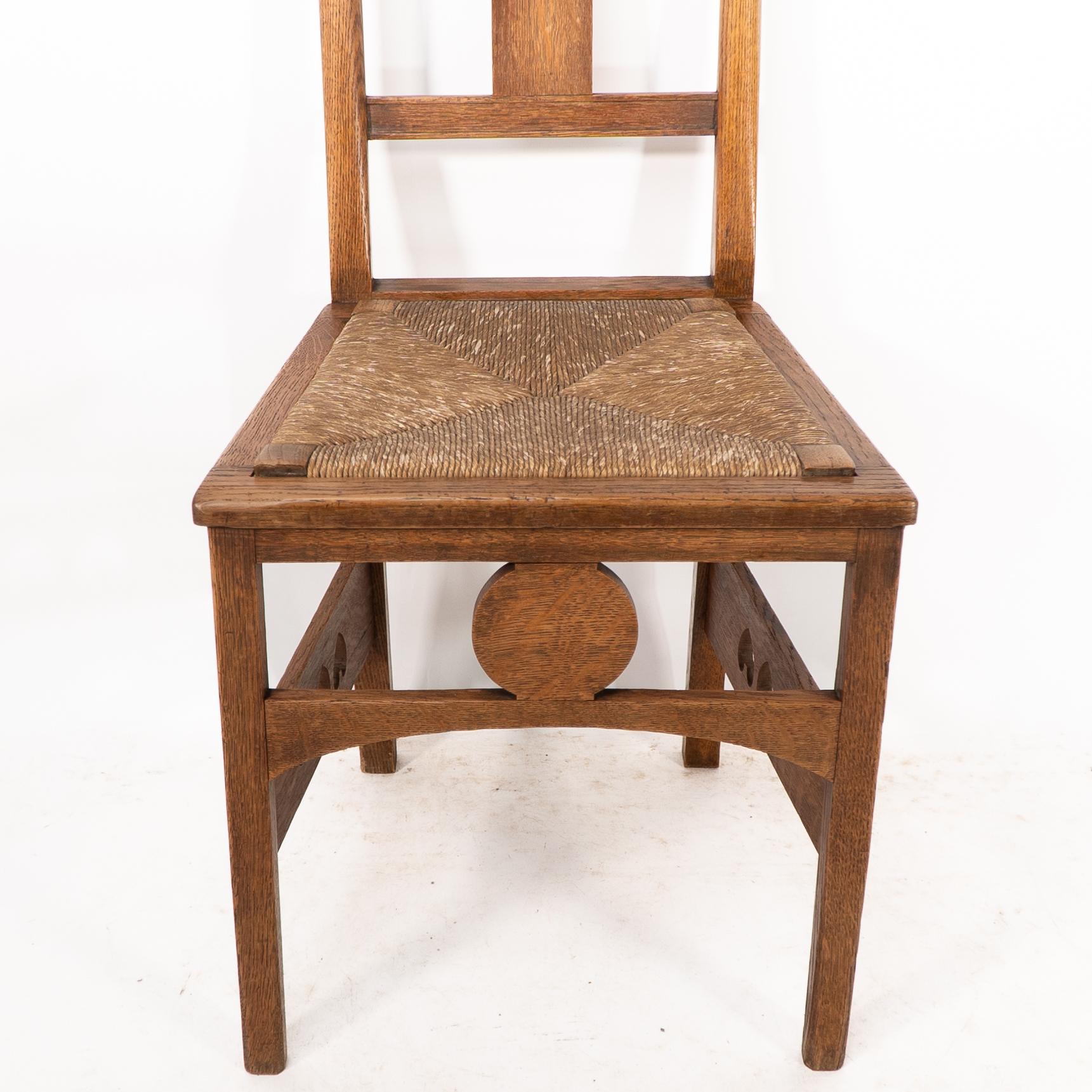 Oak Shapland & Petter. An Arts & Crafts oak desk or side chair with pierced hearts For Sale