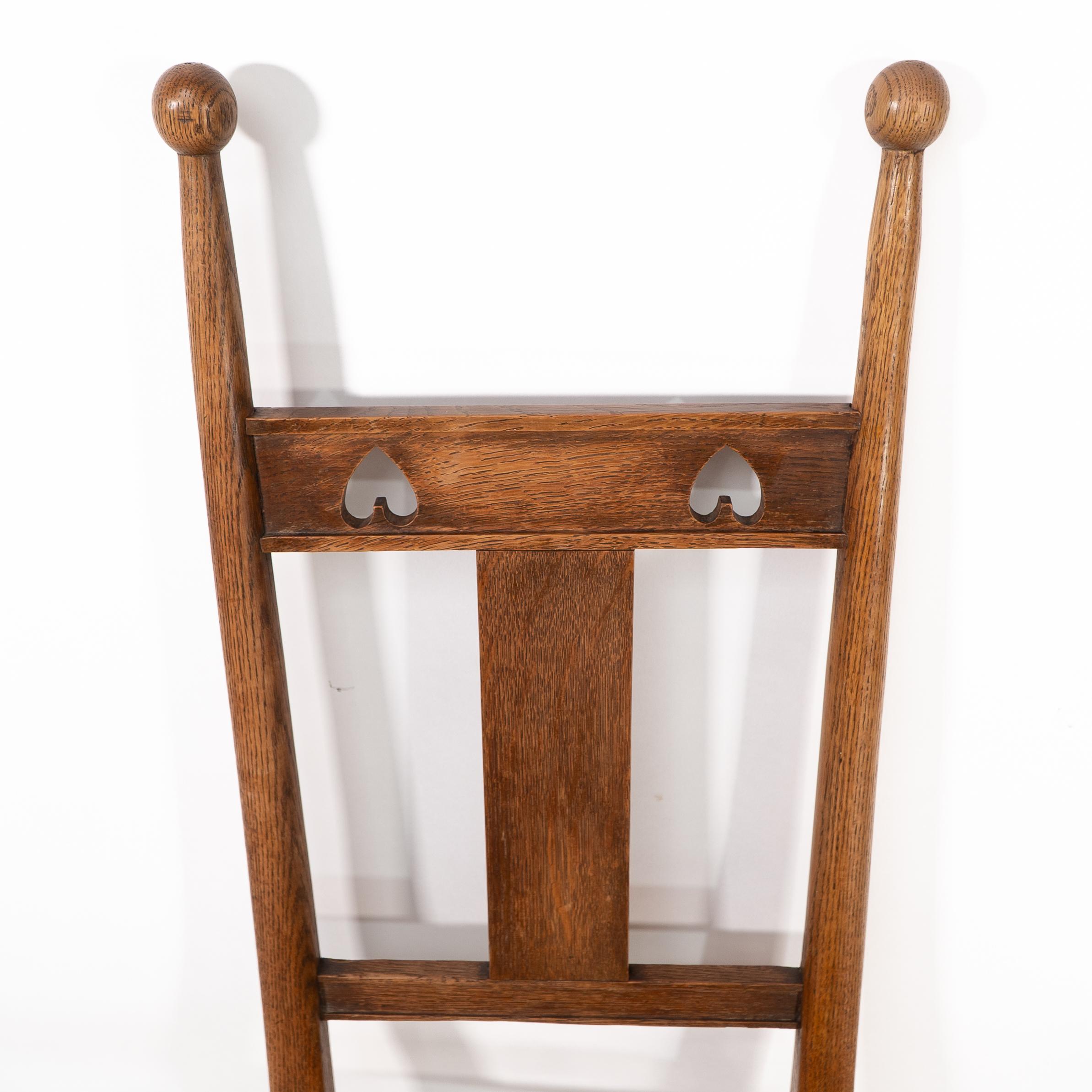 Shapland & Petter. An Arts & Crafts oak desk or side chair with pierced hearts For Sale 1