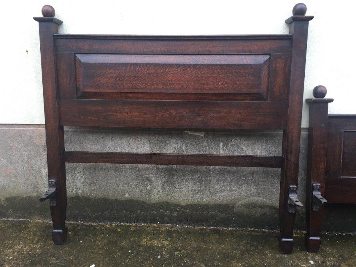 Shapland and Petter, in the style of C.F.A. Voysey
A good quality Arts & Crafts solid quarter sawn oak double bed with wonderful figuring to the oak panels and tactile round ball finials.
The image that shows it's color best is the forth