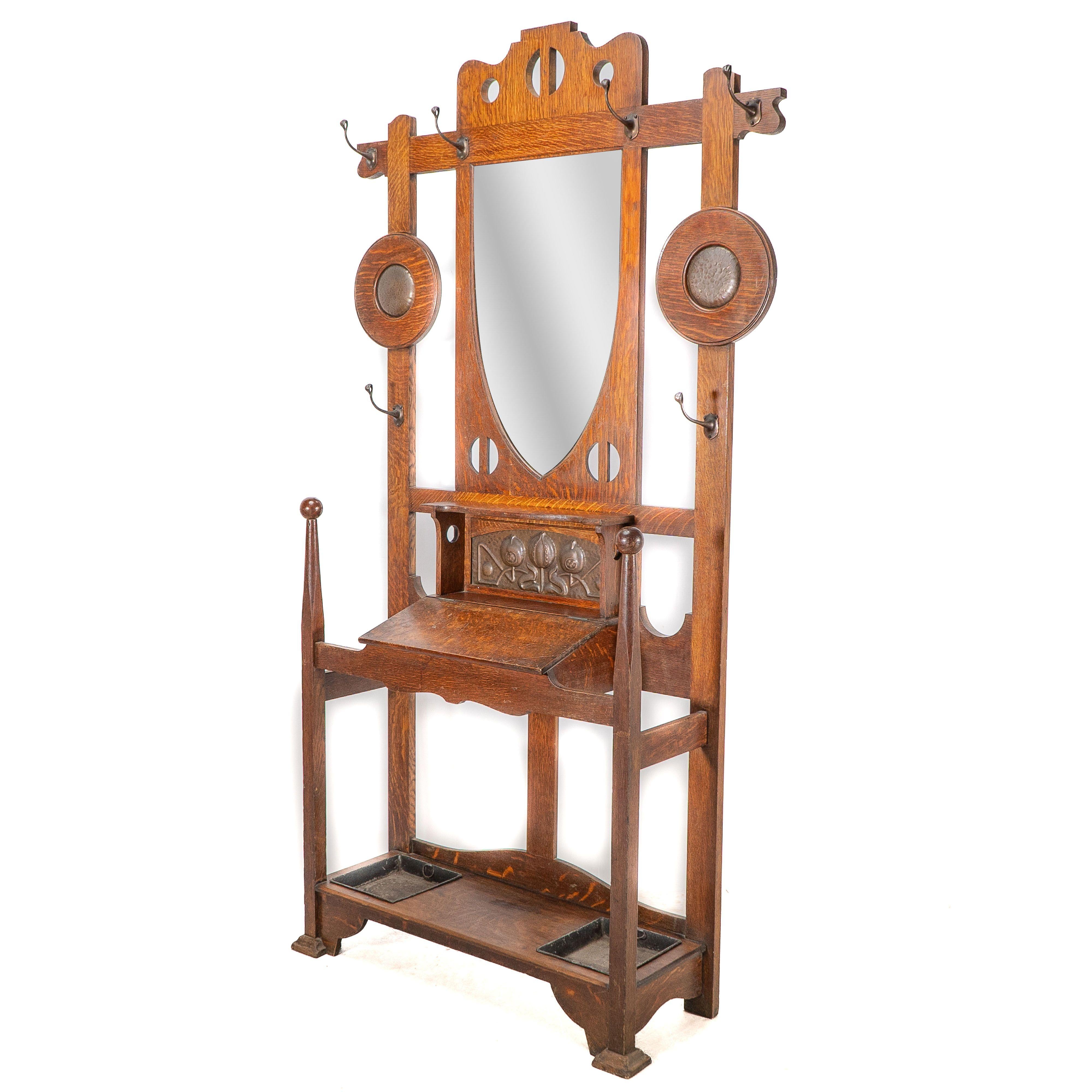 Arts and Crafts Shapland & Petter. An Arts & Crafts oak hallstand with mirror and copper panel For Sale