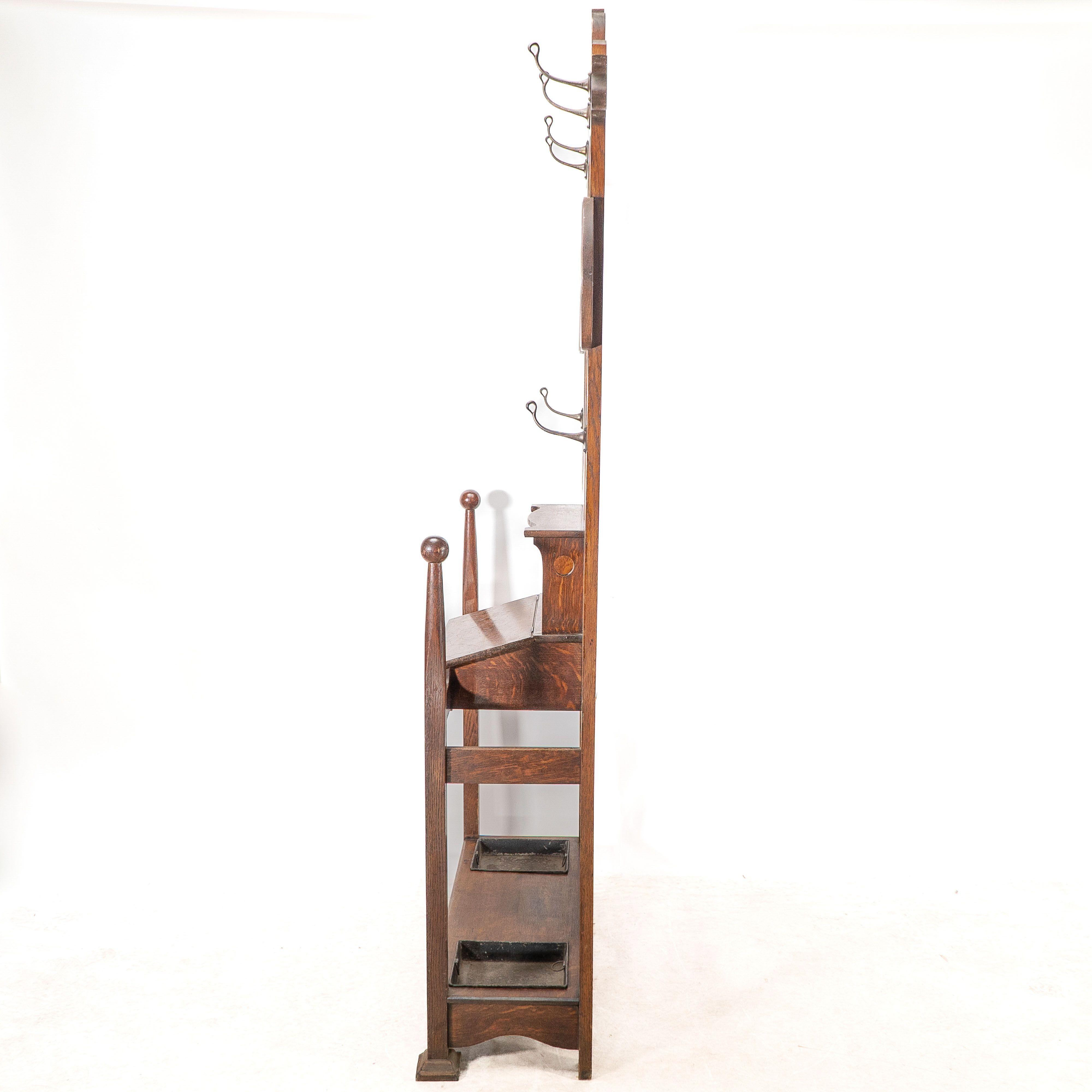 English Shapland & Petter. An Arts & Crafts oak hallstand with mirror and copper panel For Sale