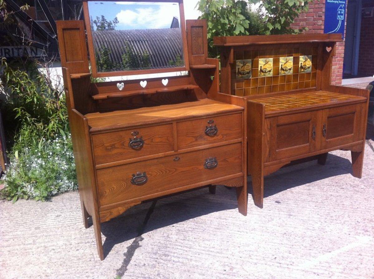 Shapland and Petter. An Arts and Crafts three drawer dressing table with pierced heart, swivel beveled mirror and stylised copper handles and escutcheons.
Wash stand has Sold.