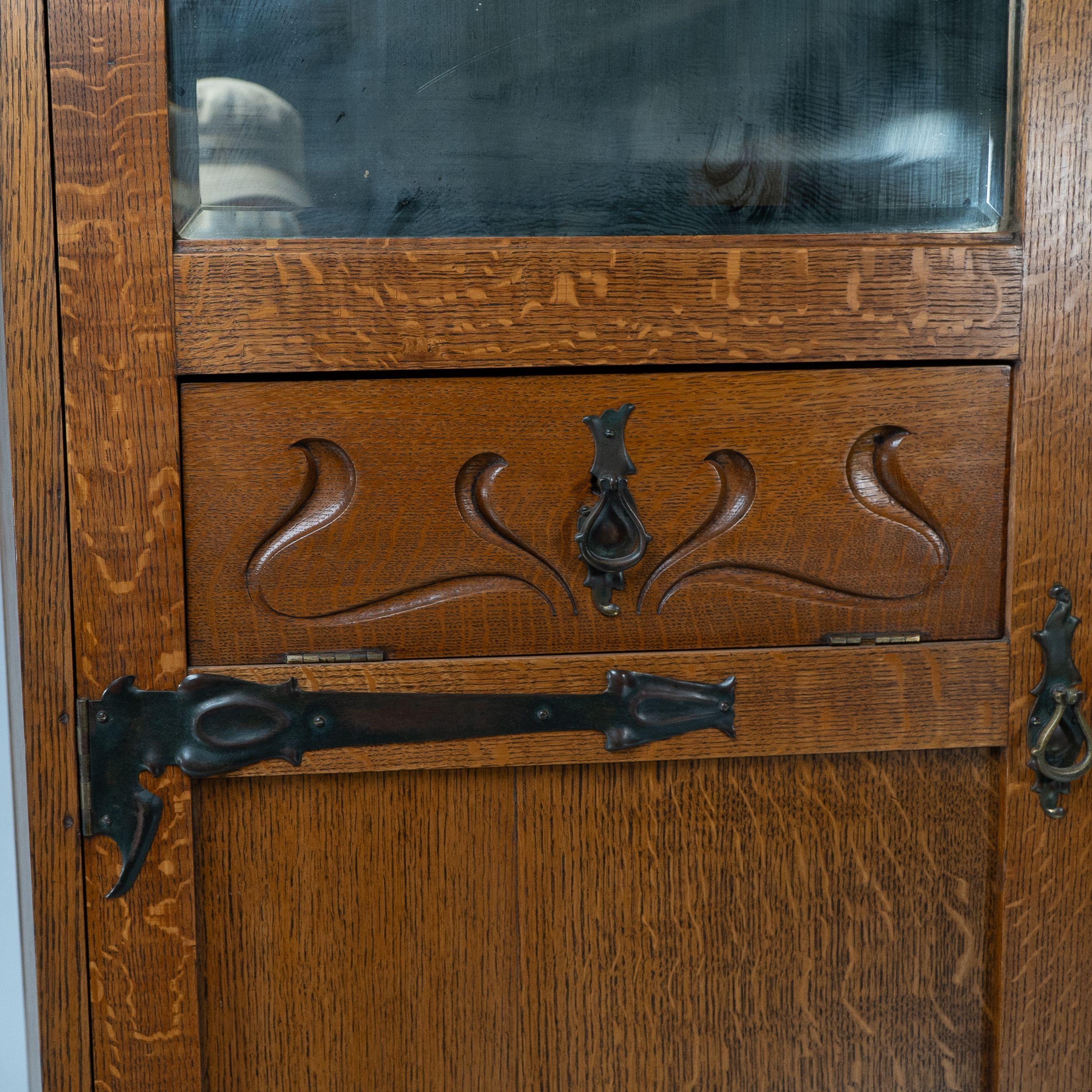 Shapland & Petter attri. An Arts & Crafts oak hall cupboard with flaring cornice For Sale 3
