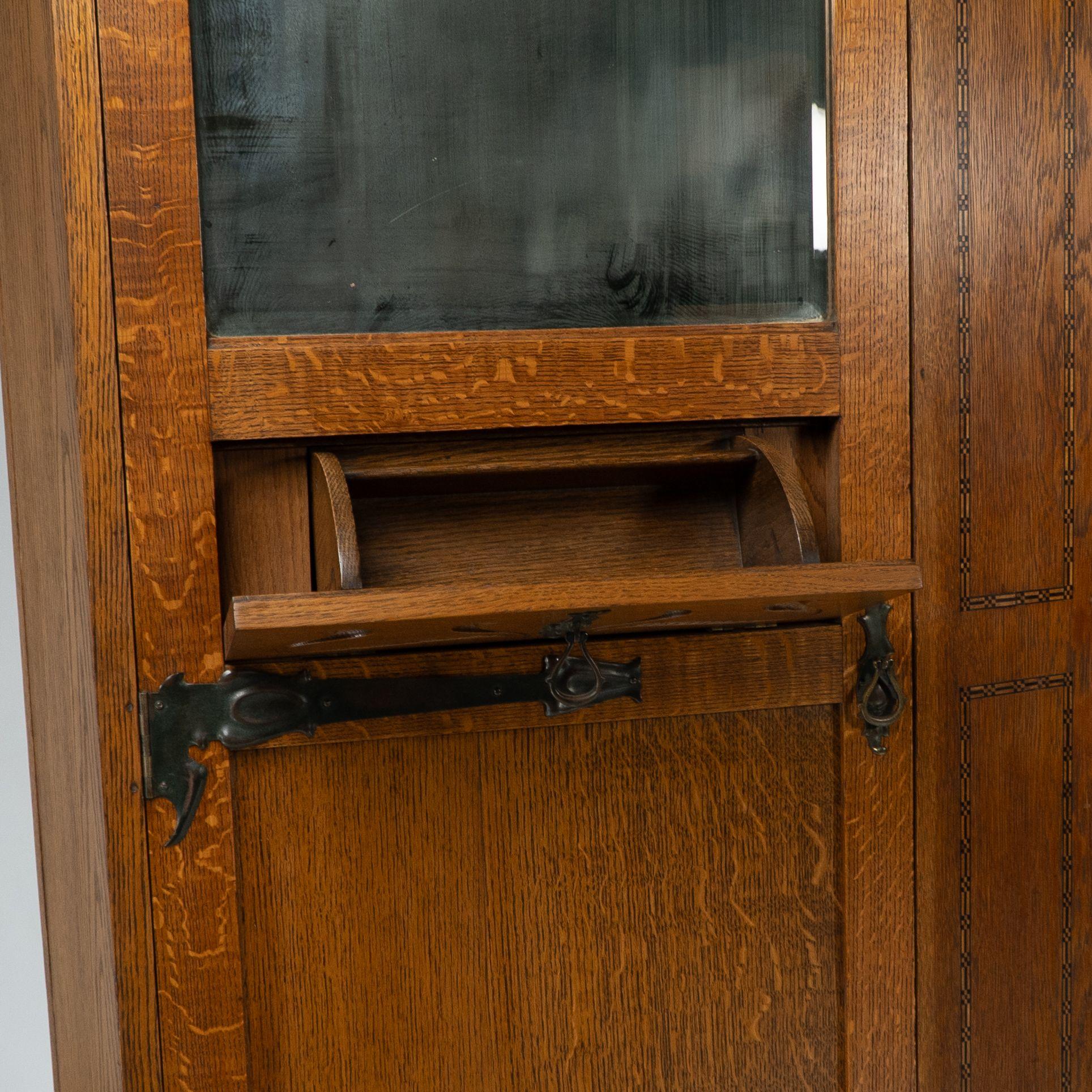 Shapland & Petter attri. An Arts & Crafts oak hall cupboard with flaring cornice For Sale 4