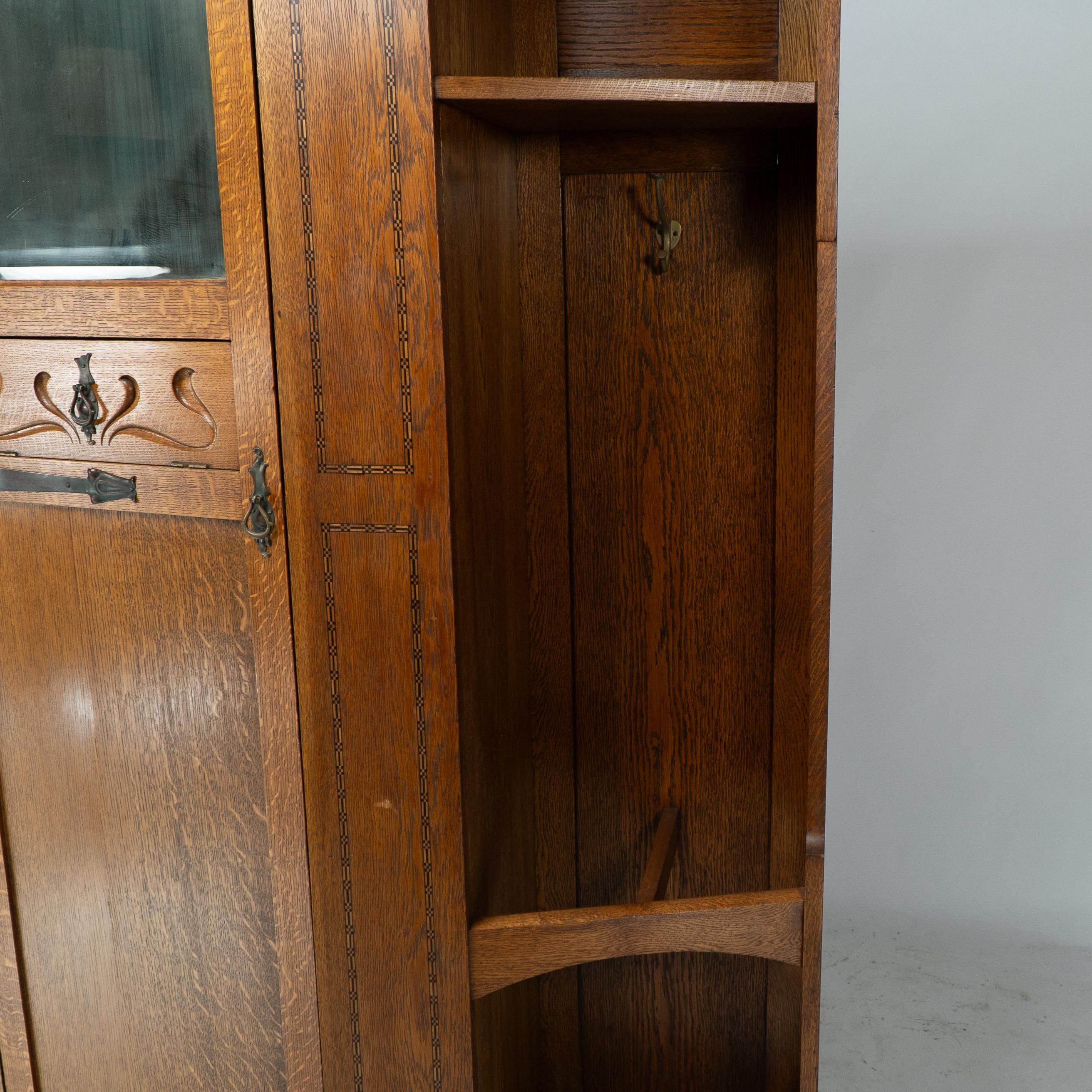 Shapland & Petter attri. An Arts & Crafts oak hall cupboard with flaring cornice For Sale 6