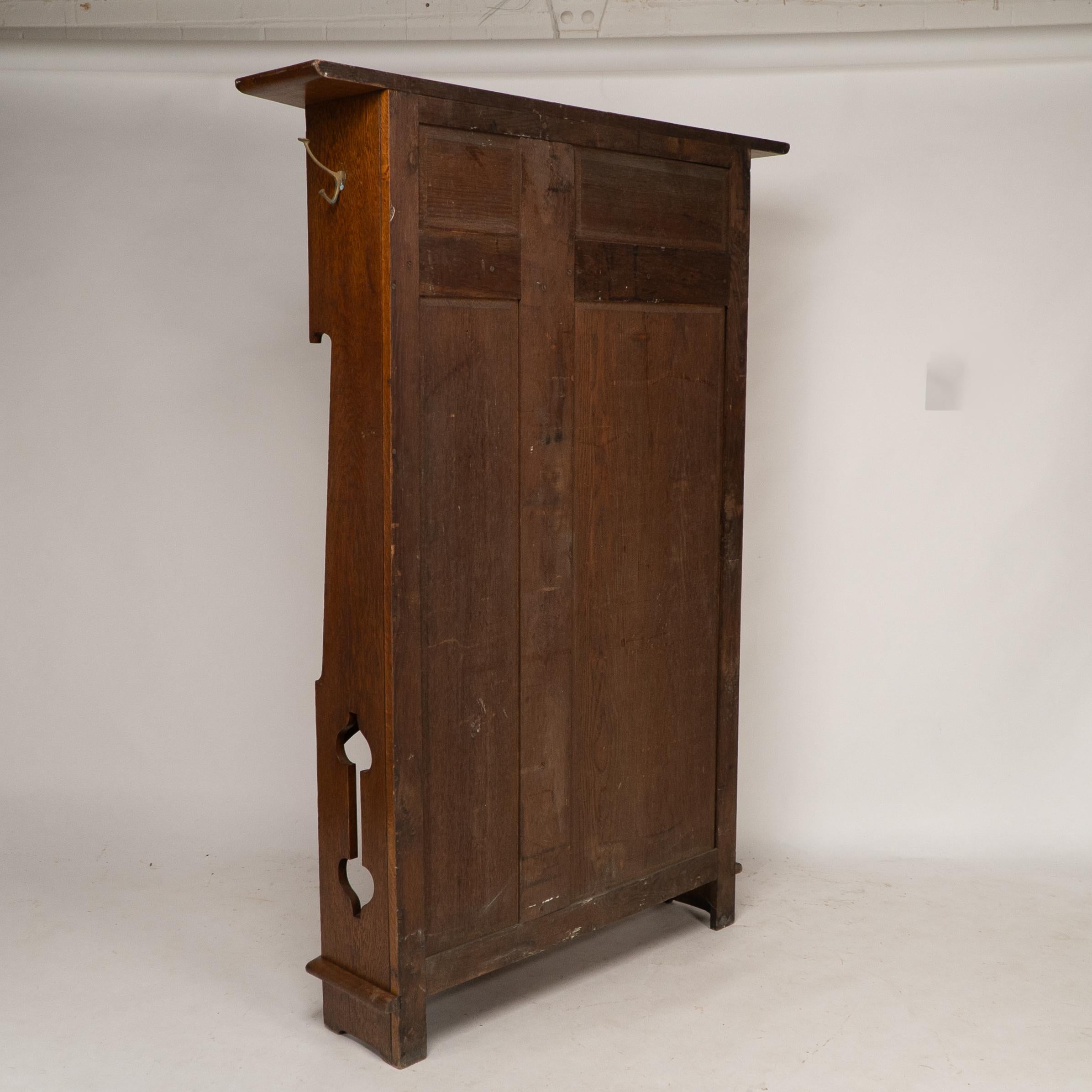 Shapland & Petter attri. An Arts & Crafts oak hall cupboard with flaring cornice For Sale 11