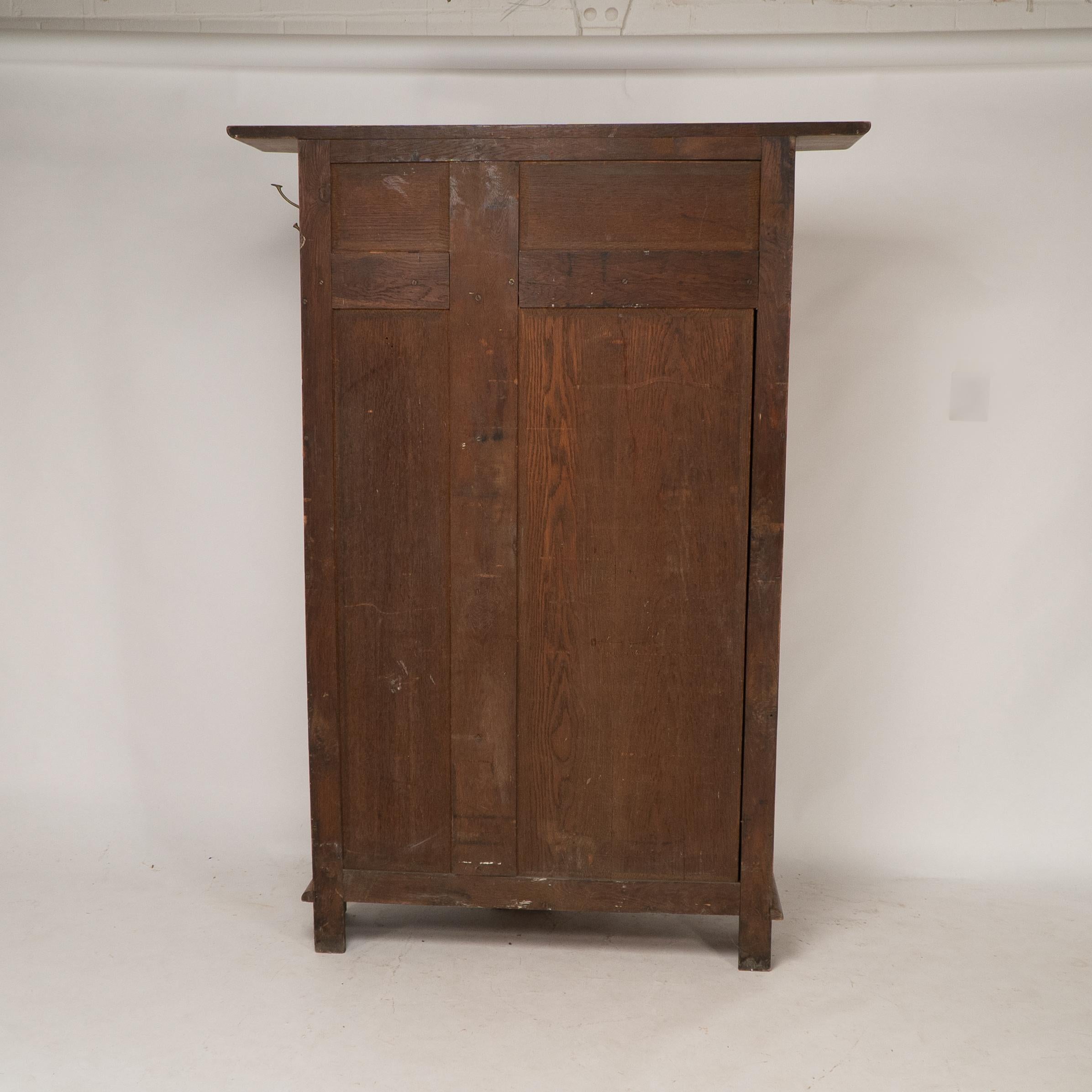 Shapland & Petter attri. An Arts & Crafts oak hall cupboard with flaring cornice For Sale 12