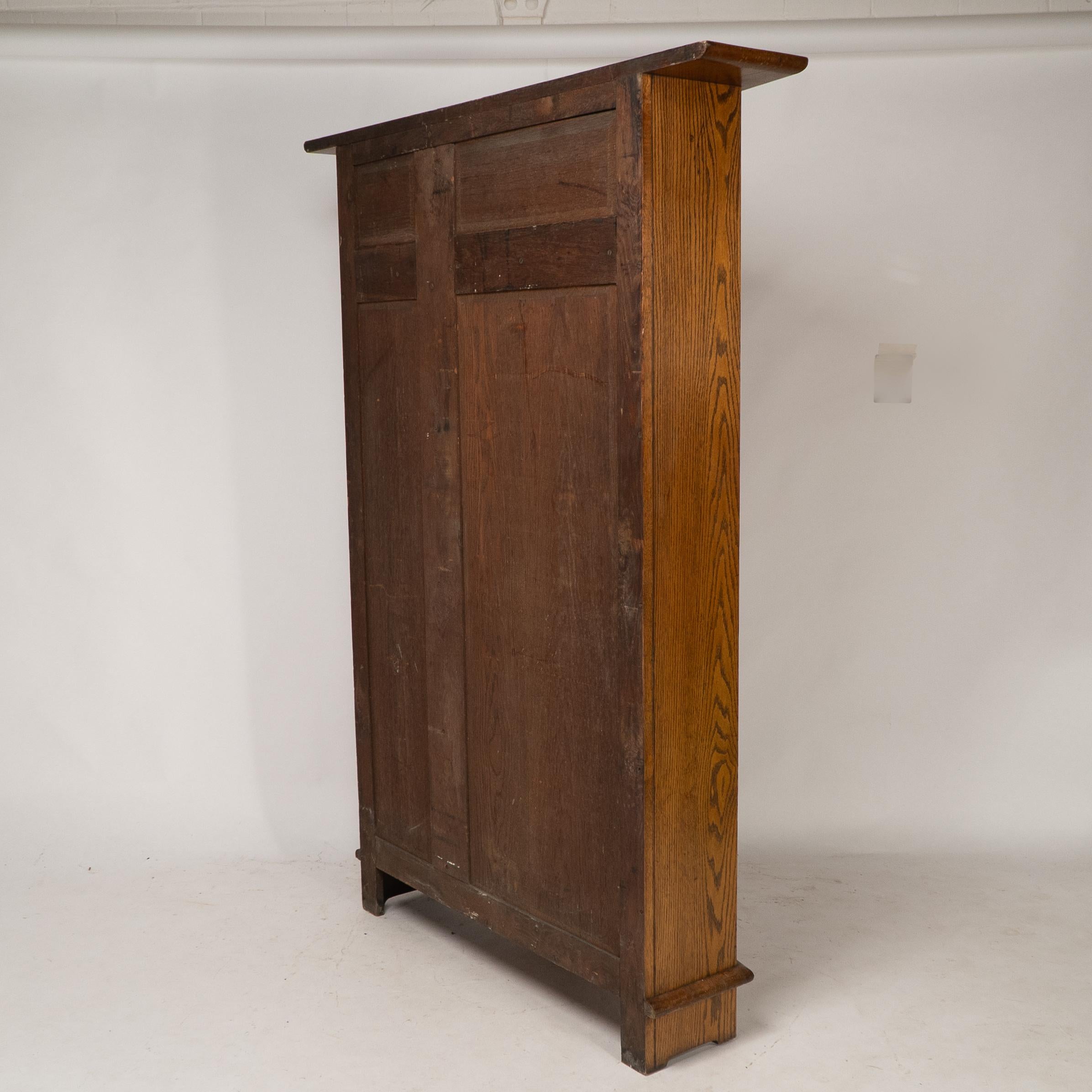 Shapland & Petter attri. An Arts & Crafts oak hall cupboard with flaring cornice For Sale 13